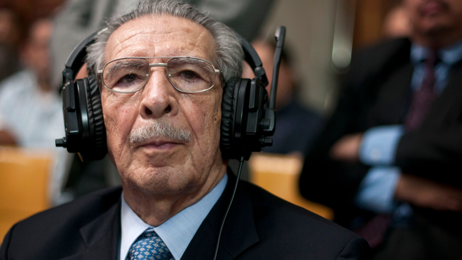 Guatemala's former dictator Jose Efrain Rios Montt wears headphones as he listens to the verdict in his genocide trial in Guatemala City, Friday, May 10, 2013. The Guatemalan court convicted Rios Montt on charges of genocide and crimes against humanity, sentencing him to 80 years in prison. The 86-year-old former general is the first former Latin American leader ever found guilty of such a charge. The war between the government and leftist rebels cost more than 200,000 lives and ended in peace accords in 1996. (AP Photo/Luis Soto)
