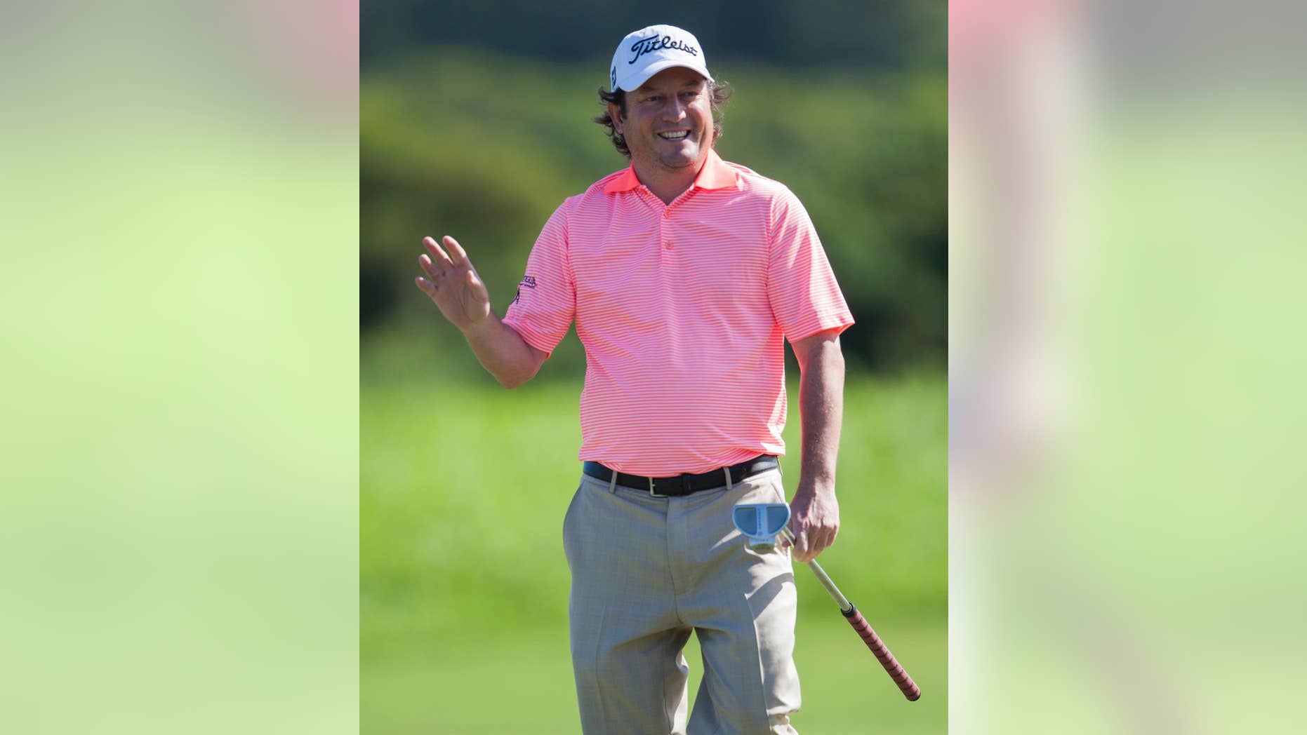Tim Clark, of South Africa, waves to the gallery after making a birdie putt on the second green during the first round of the Tournament of Champions golf tournament, Friday, Jan. 9, 2015, in Kapalua, Hawaii. (AP Photo/Marco Garcia)