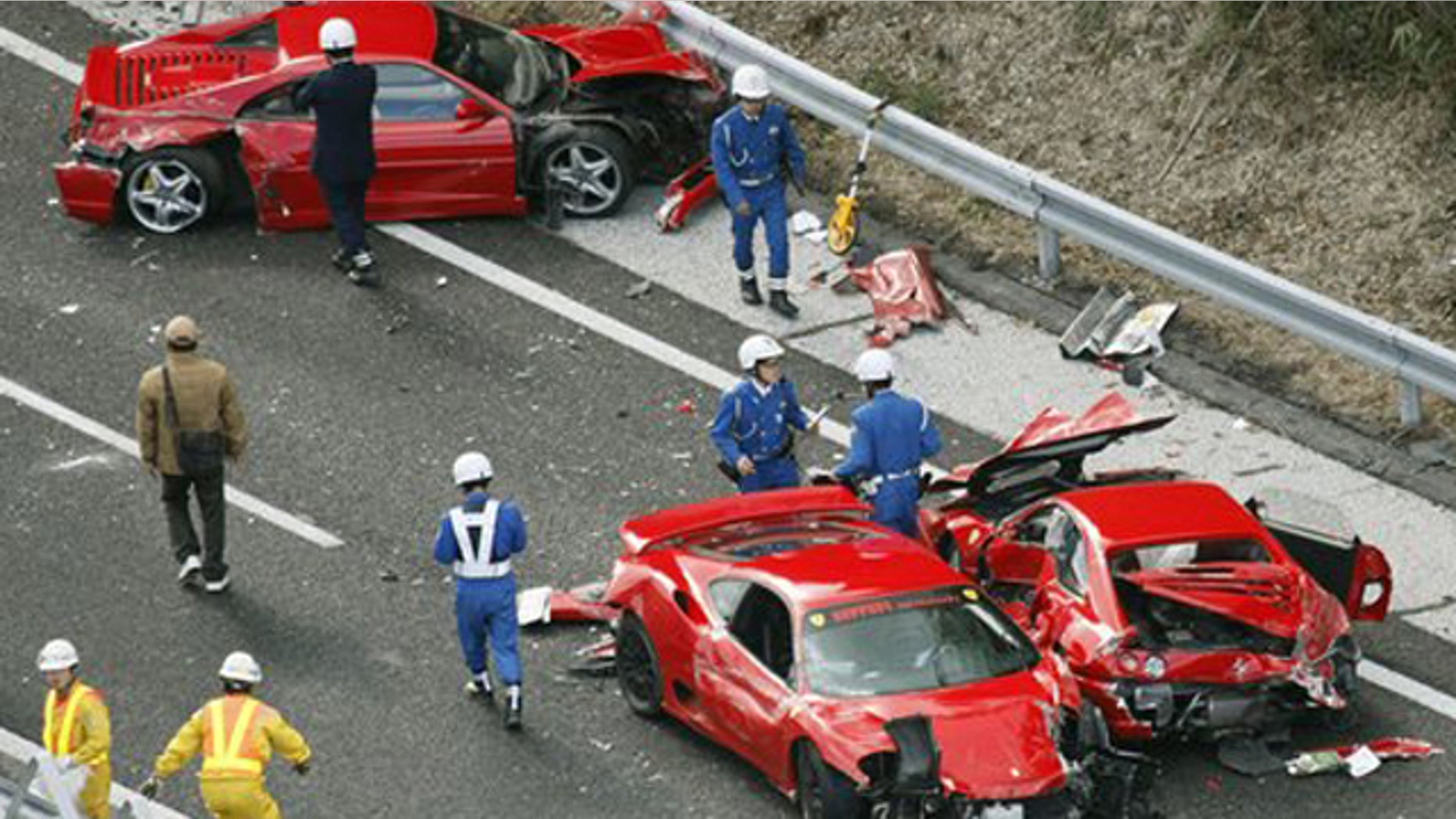 December 4, 2011: Police officers investigate damaged Ferrari cars at the site of a traffic accident on the Chugoku Expressway in Shimonoseki, southwestern Japan.