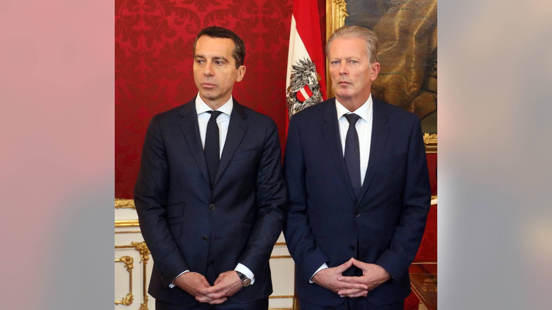 New Austrian Chancellor Christian Kern and Vice Chancellor Reinhold Mitterlehner, from left, attend an inauguration ceremony of four new ministers at the Hofburg palace in Vienna, Austria, Wednesday, May 18, 2016. (AP Photo/Ronald Zak)