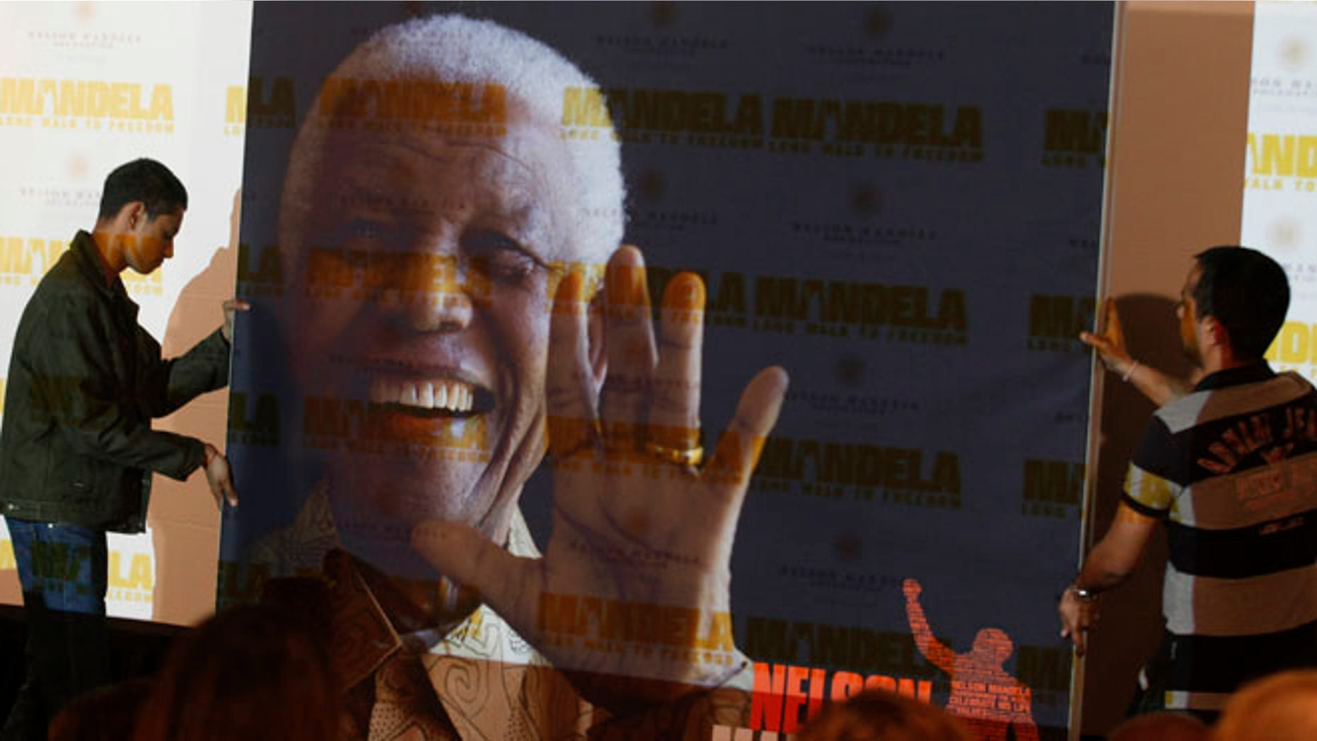 Nov. 2, 2013: In this file photo, a giant poster of Nelson Mandela is moved to center stage at a news conference held to promote the newly released film "Mandela: Long Walk To Freedom," in Johannesburg.