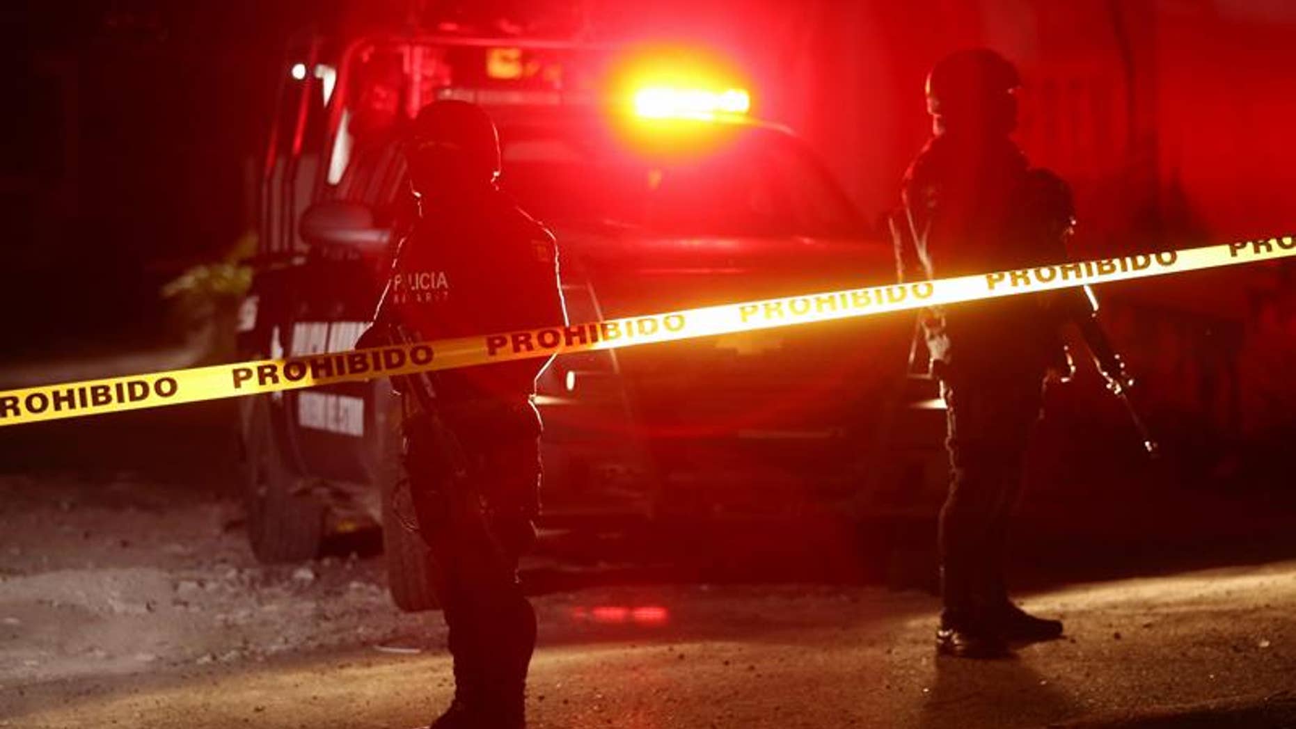 State and federal police on Feb. 10, 2017, guard a crime scene in Tepic, Nayarit where Juan Francisco Padron Sanchez, a suspected regional leader of the Beltran Leyva drug cartel, was killed in a shootout with federal forces.