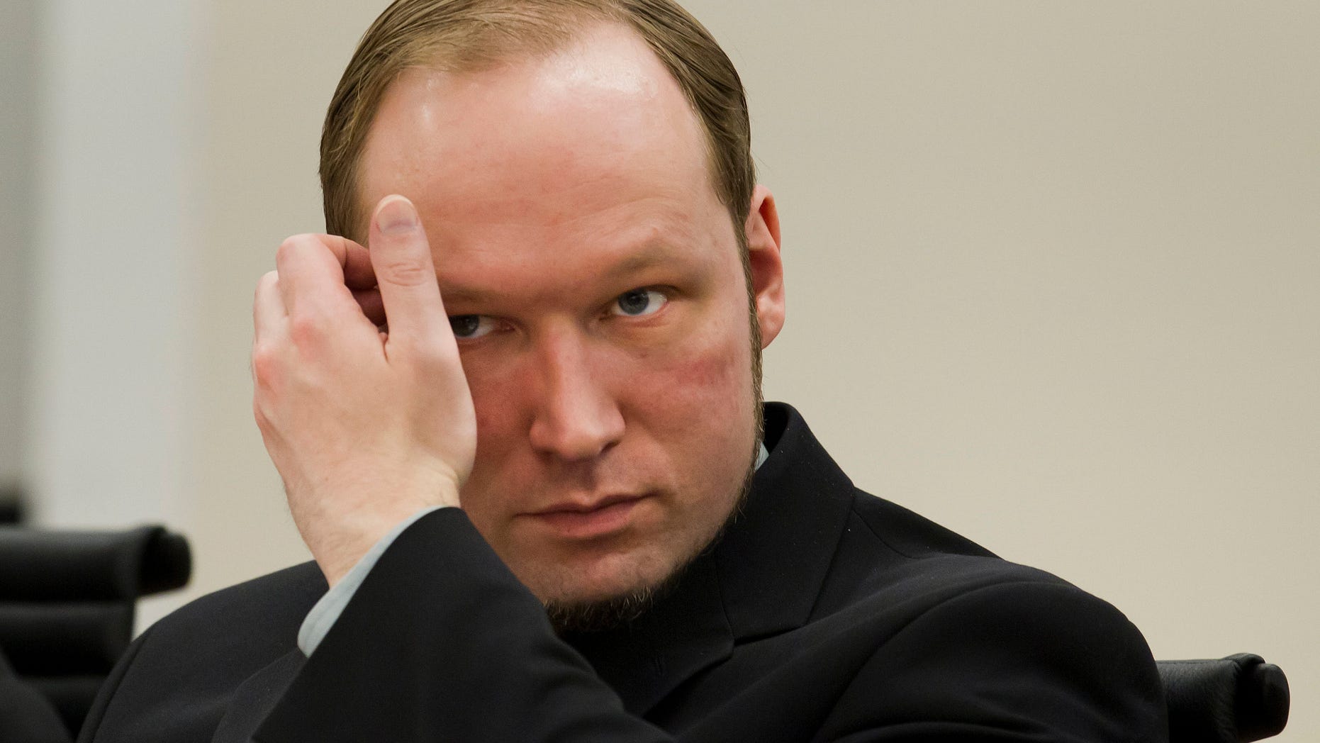 Confessed mass killer Anders Behring Breivik sits in the courtroom in Oslo, Norway Friday 1 June, 2012. Norwegian police said they are confident that confessed mass killer Anders Behring Breivik acted on his own in terror attacks last year that killed 77 people and that they found no evidence he belonged to a Europe-wide anti-Muslim network. (AP Photo/Heiko Junge,Pool)