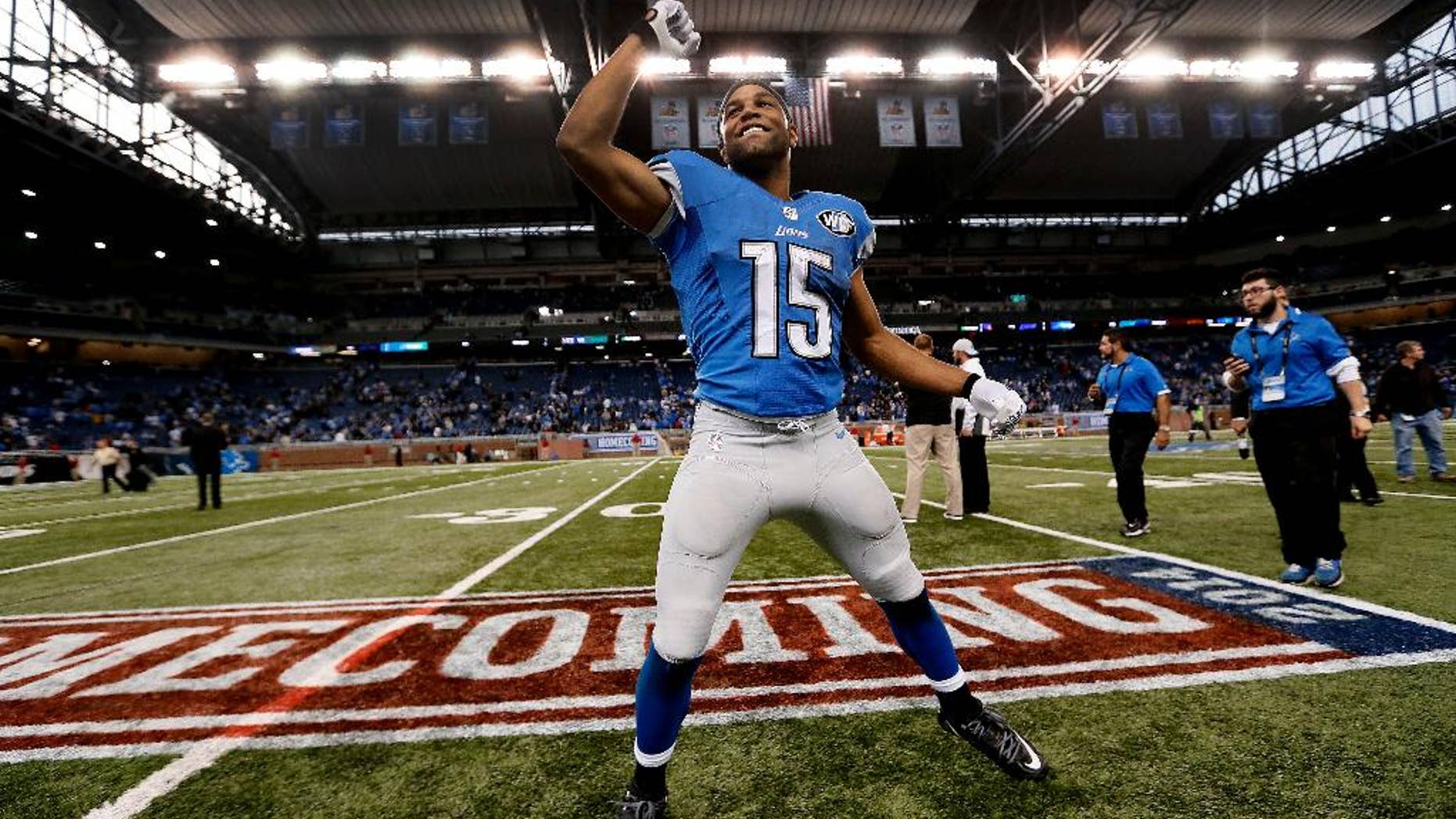 Detroit Lions wide receiver Golden Tate celebrates their 24-23 victory over the New Orleans Saints after a NFL football game in Detroit, Sunday, Oct. 19, 2014. (AP Photo/Paul Sancya)