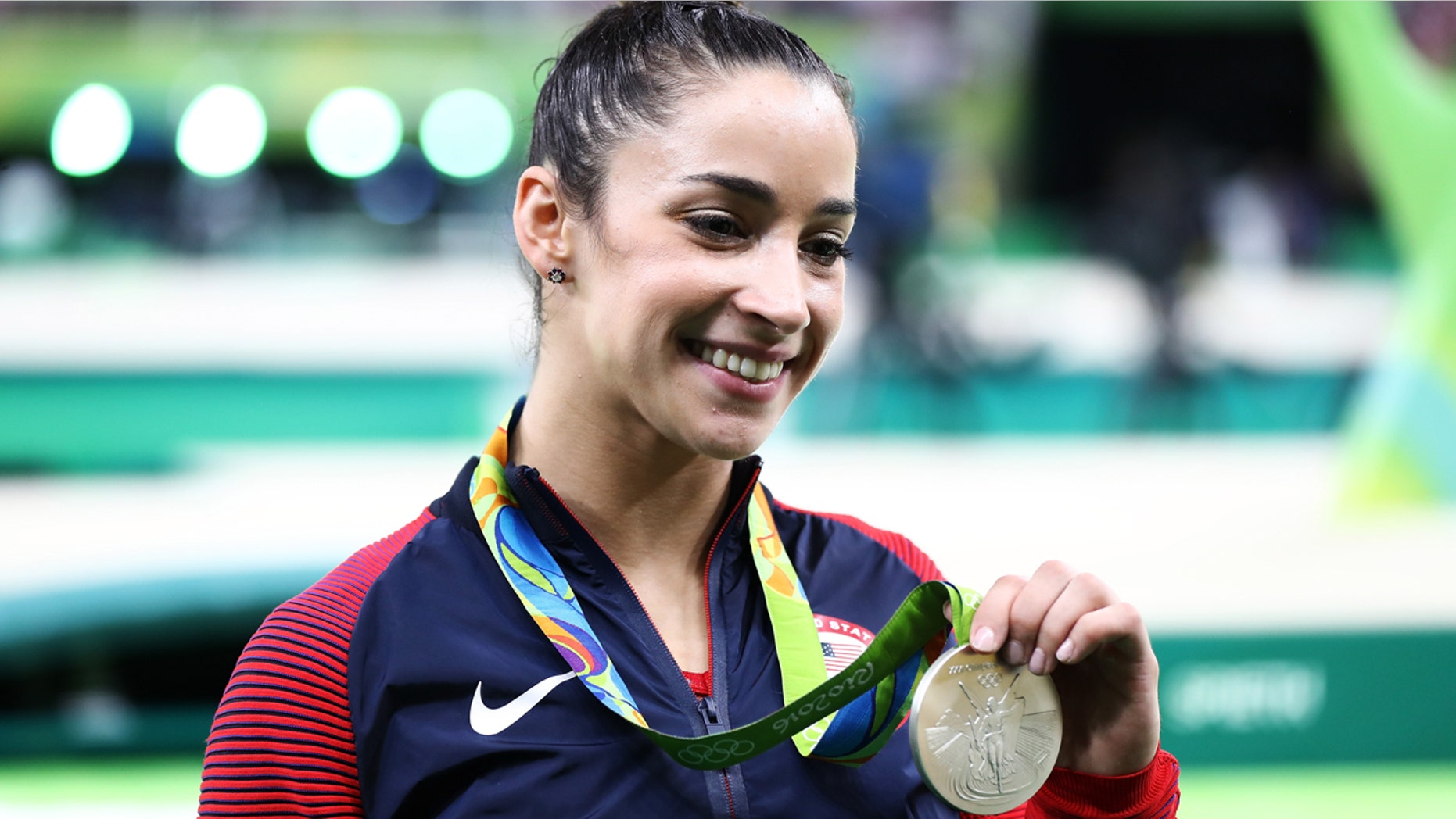 Silver medalist Alexandra Raisman of the United States poses for photographs after the medal ceremony for the Women's Individual All Around on Day 6 of the 2016 Rio Olympics at Rio Olympic Arena on August 11, 2016 in Rio de Janeiro, Brazil.