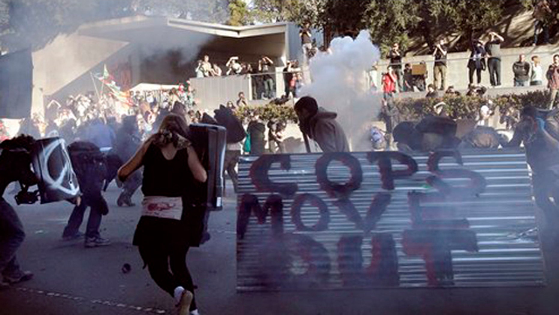 January 28, 2012: Oakland police deploy smoke and tear gas to stop protesters with the Occupy Oakland as they march through the streets of downtown Oakland, Calif.