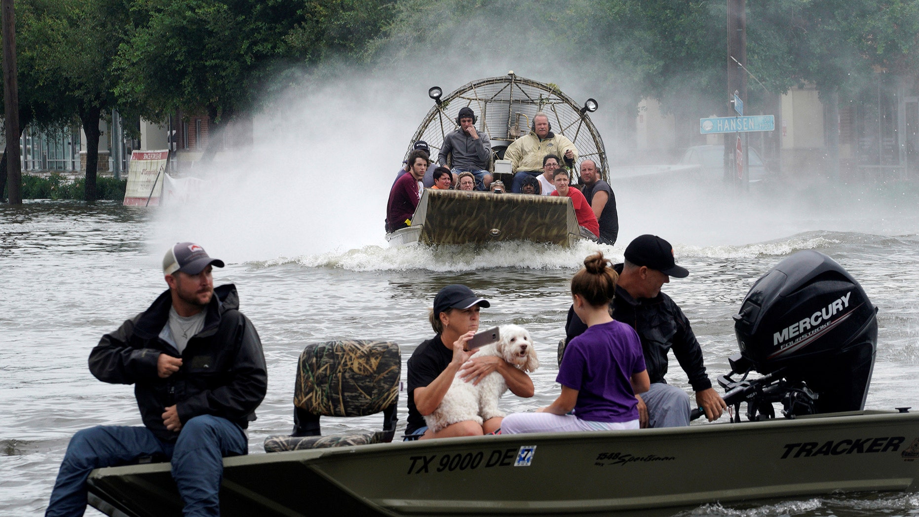 People are rescued from flood waters from Hurricane Harvey on an air boat in Dickinson, Texas August 27, 2017. REUTERS/Rick Wilking - RTX3DKR1