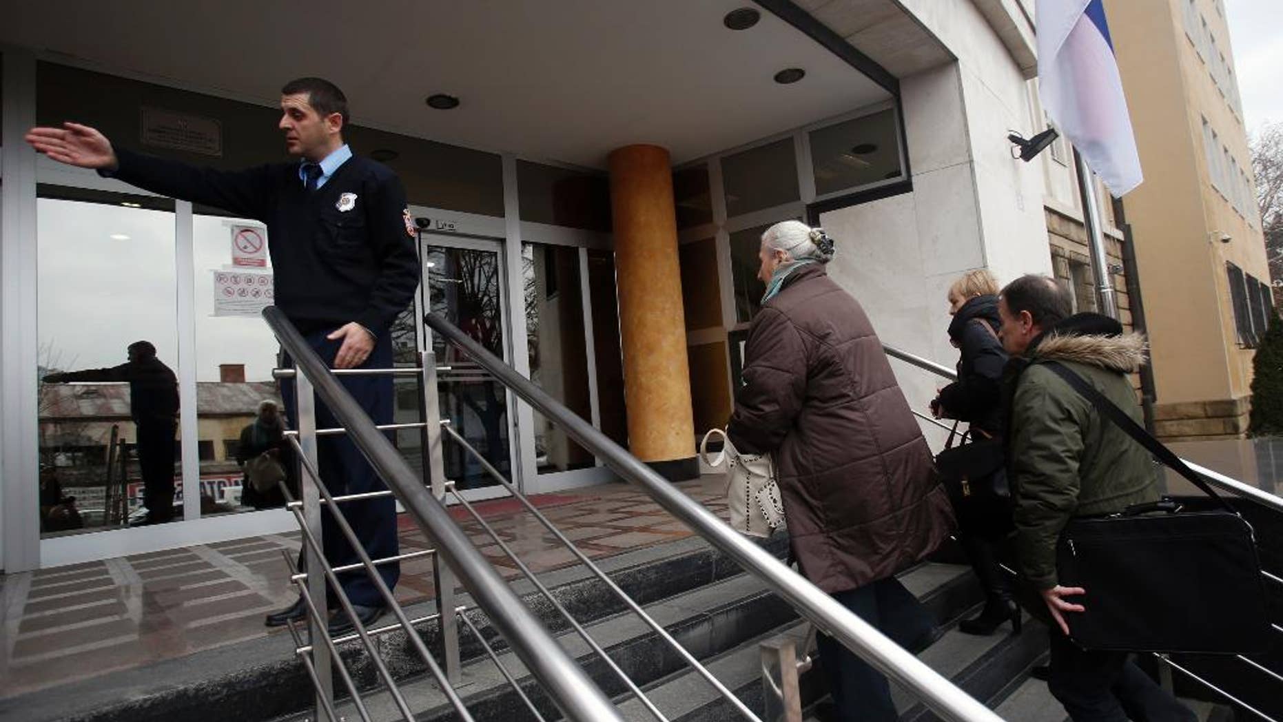 Family members of killed Bosnian Muslim men and boys arrive at the special court building in Belgrade, Serbia, Monday, Dec. 12, 2016. Eight former Bosnian Serb special police troops went on trial Monday in Serbia charged with taking part in the massacre of thousands of Muslims in Srebrenica in 1995 - a landmark proceedings testing the Balkan country's proclaimed pledge to deal with its wartime past. (AP Photo/Darko Vojinovic)