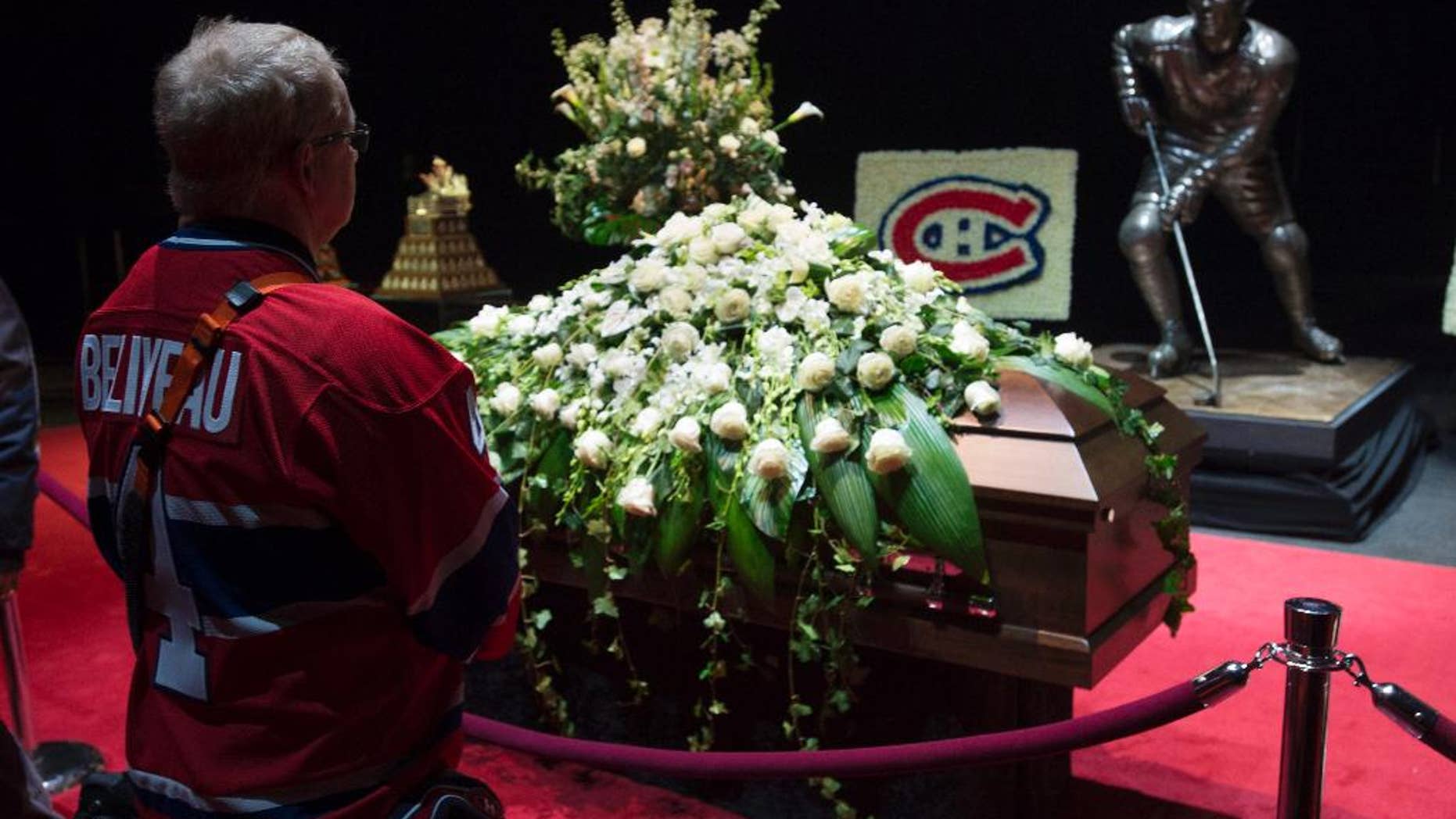 Mourners pay their respect to Montreal Canadiens legend Jean Beliveau during the public viewing for the Montreal Canadiens legend Jean Beliveau Sunday, Dec. 7, 2014, in Montreal. (AP Photo/The Canadian Press, Paul Chiasson)