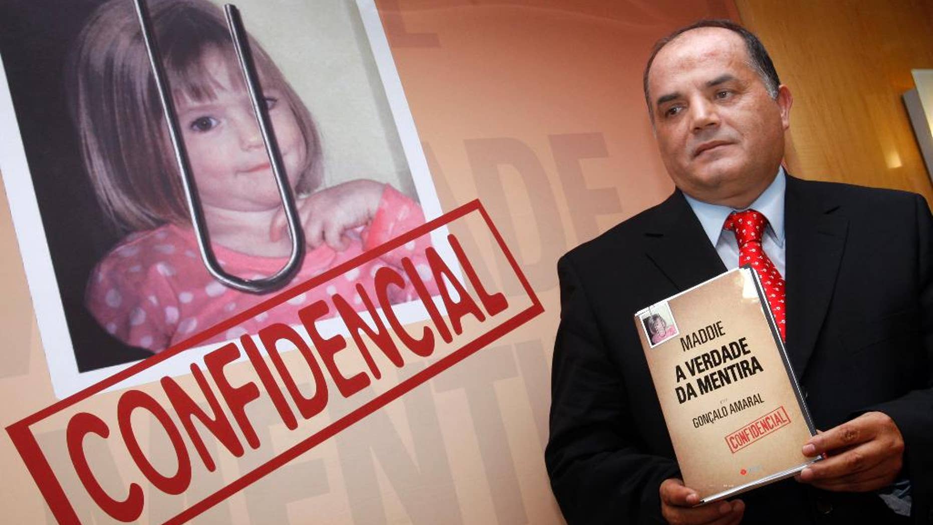 FILE- In this July 24, 2008 file photo, former detective Goncalo Amaral in the Madeleine McCann case poses next to her photo with his book, whose title translates as "The Truth in the Lies", during its launch in Lisbon. British detectives say they are still pursuing "critical" leads in the case of the disappearance of Madeleine McCann, 10 years after the girl — then three years old — vanished from a vacation home in Portugal. Metropolitan Police Assistant Commissioner Mark Rowley said Wednesday, April 26, 2017 there are "significant investigative avenues ... of great interest" to detectives both in Britain and in Portugal. (AP Photo/Joao Henriques, file)
