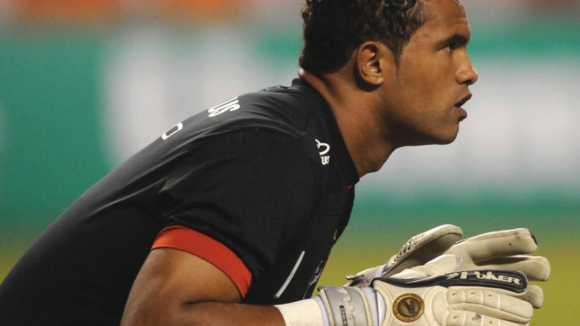 FILE - This April 7, 2010 file photo shows Flamengo's goalkeeper Bruno Fernandes de Souza during a soccer game in Rio de Janeiro, Brazil. Boa Esporte, a Brazilian soccer club, presented Souza on Tuesday, March 14, 2017, to announce his signing as goalkeeper. Souza was convicted in the killing of an ex-girlfriend, prompting outrage from many. He is free while appealing a 22-year prison sentence. (AP Photo/Felipe Dana, File)