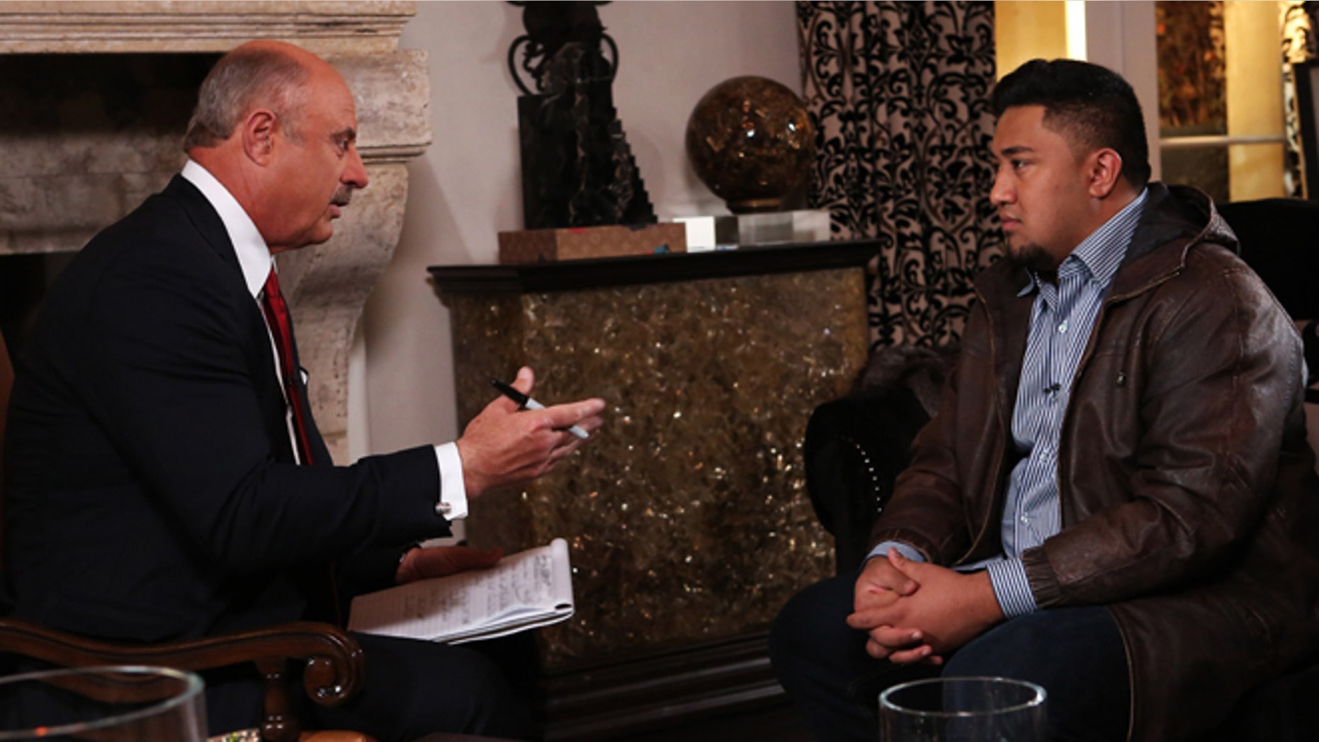 In this Jan. 24, 2013, photo provided by CBS Television Distribution/Peteski Productions, talk show host Dr. Phil McGraw, left, interviews Ronaiah Tuiasosopo during taping for the "Dr. Phil Show" in Los Angeles.