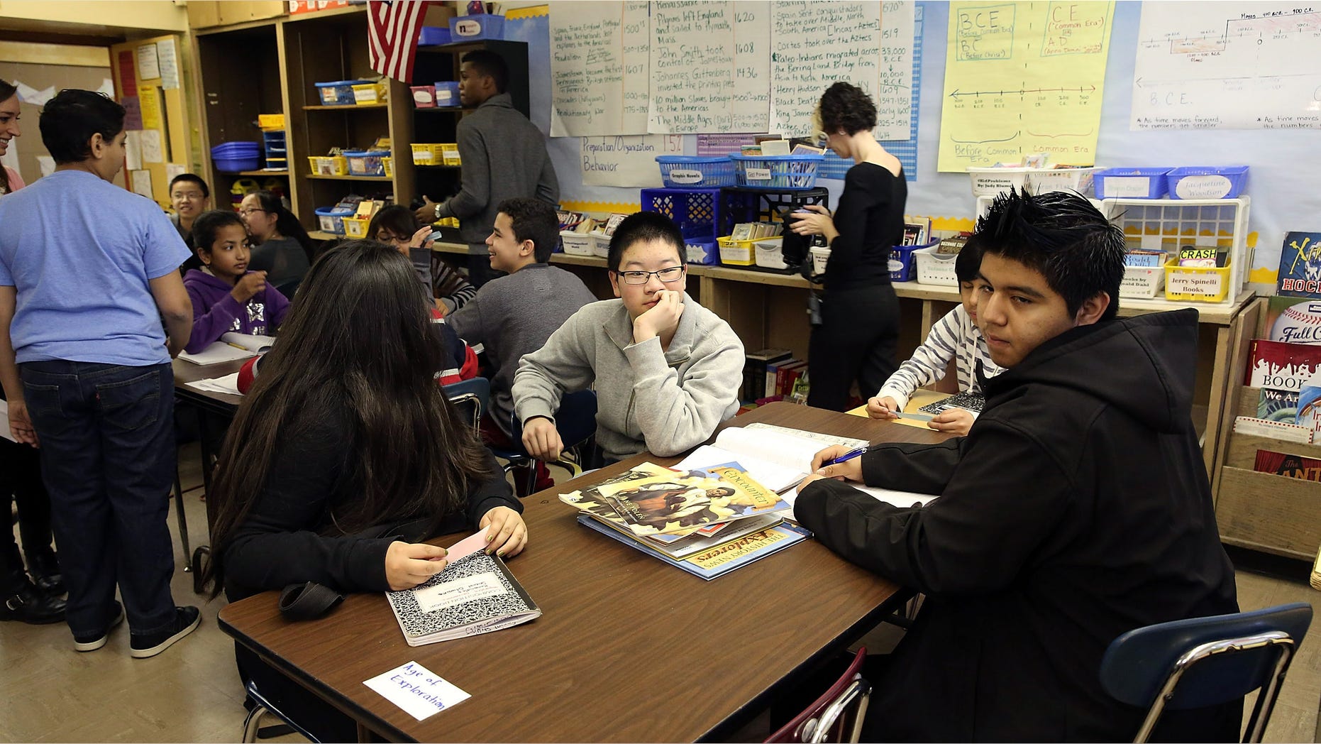 NEW YORK, NY - APRIL 07: Students wait for New York City Schools Chancellor Carmen Farina while she visits J.H.S. 088 Peter Rouget school in Brooklyn to announe the new initiative called "Learning Partners Program" on April 7, 2014 in New York City. The program aims to bring schools together to better share and coordinate successful practices in the classroom. (Photo by Spencer Platt/Getty Images)