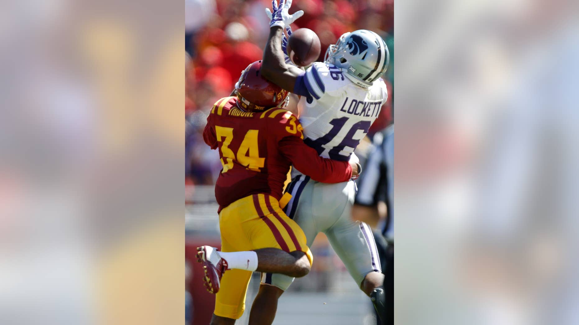 Kansas State wide receiver Tyler Lockett (16) hauls in a pass over Iowa State defensive back Nigel Tribune (34) during the second half of an NCAA college football game Saturday, Sept. 6, 2014, in Ames, Iowa. Kansas State won 32-28. (AP Photo/Justin Hayworth)