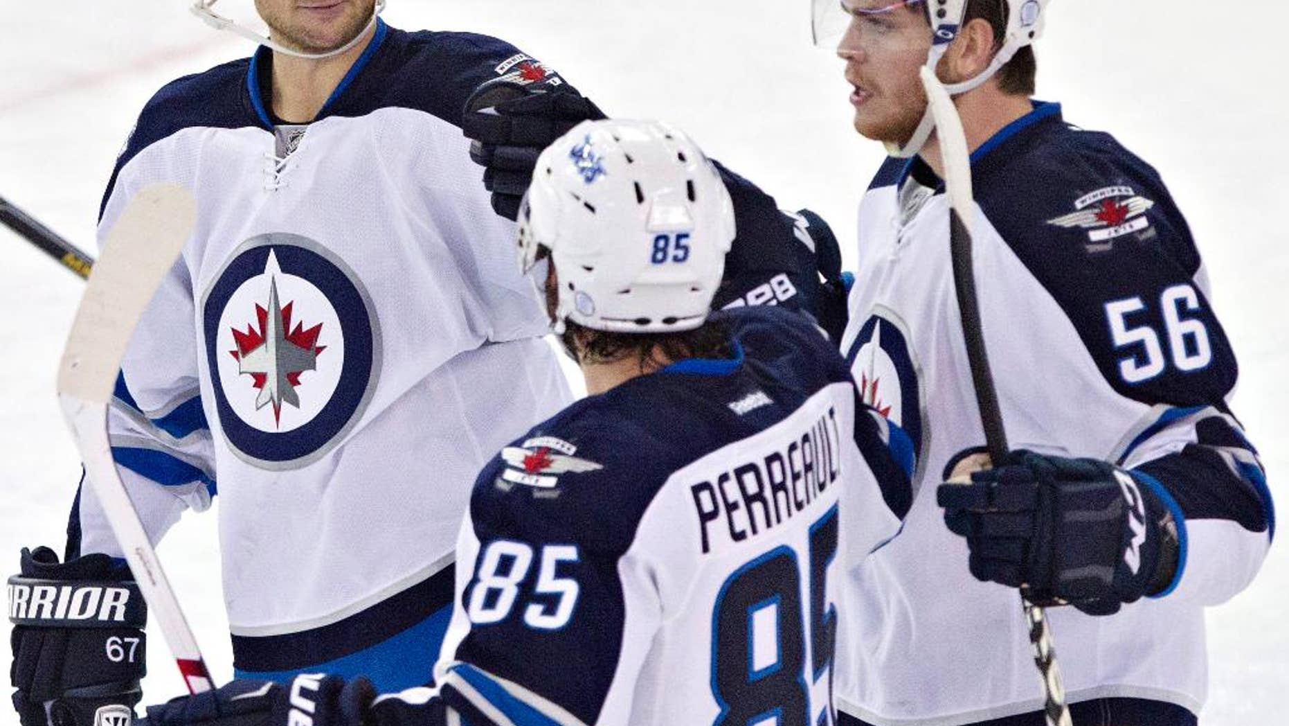 Winnipeg Jets Michael Frolik (67), Mathieu Perreault (85)and Adam Lowry (56) celebrate a goal against the Edmonton Oilers during second period NHL hockey action in Edmonton, Alberta, on Monday, Sept. 29, 2014.(AP Photo/The Canadian Press, Jason Franson)