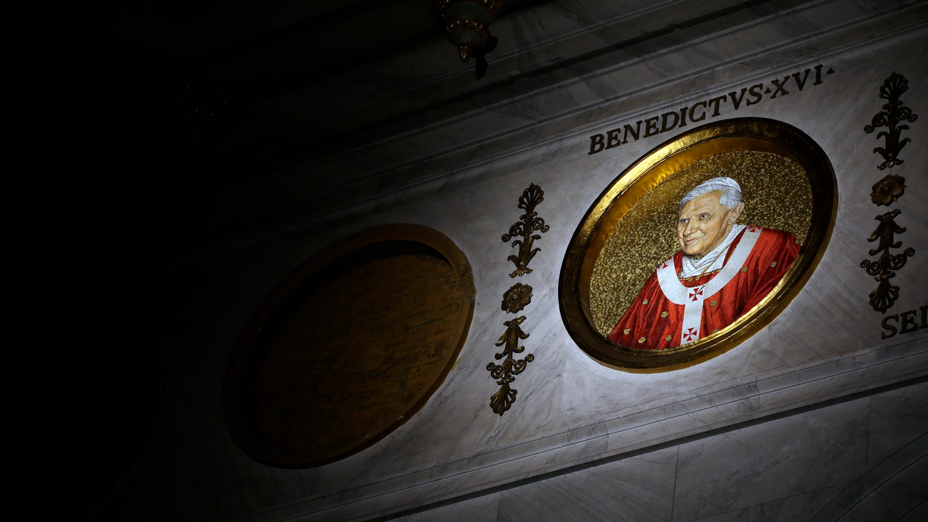 The icon of Pope Benedict XVI is lit inside St. Paul Outside the Walls Basilica, in Rome,Tuesday, Feb.12, 2013. With a few words in Latin, Pope Benedict XVI did what no pope has done in more than half a millennium, stunning the world by announcing his resignation Monday, Feb. 11, 2013, and leaving the already troubled Catholic Church to replace the leader of its 1 billion followers by Easter. (AP Photo/Gregorio Borgia)