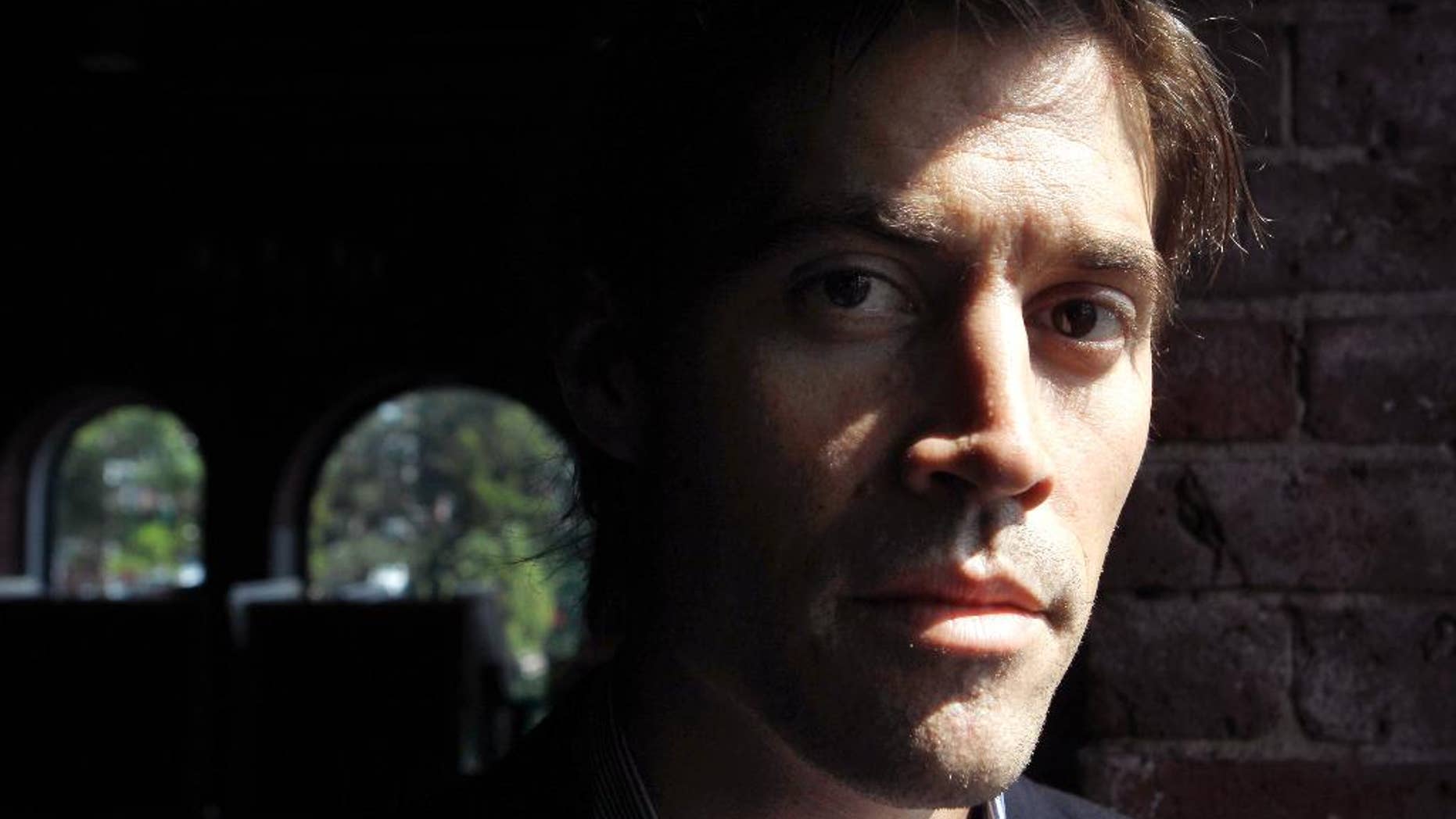 FILE - In this May 27, 2011, file photo shows American Journalist James Foley, of Rochester, N.H., as he poses for a photo in Boston. The beheading of Foley has forced a new debate over how the United States balances its unyielding policy against paying ransom to terrorist groups and saving the lives of Americans being held hostage by some of the world’s most dangerous extremists. (AP Photo/Steven Senne, File)