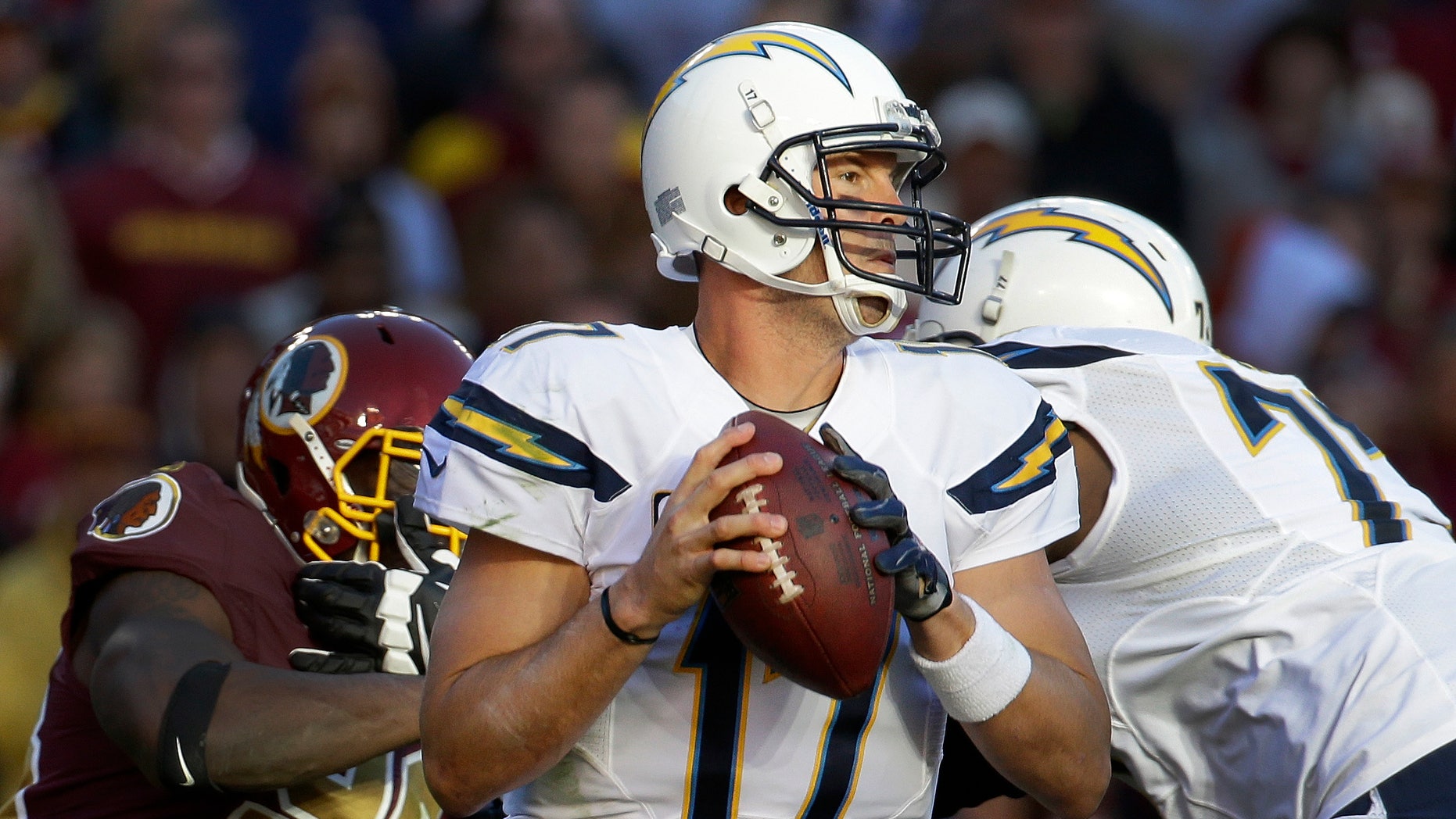 San Diego Chargers quarterback Philip Rivers looks for an open man to pass during the second half of a NFL football game against Washington Redskins in Landover, Md., Sunday, Nov. 3, 2013. (AP Photo/Alex Brandon)