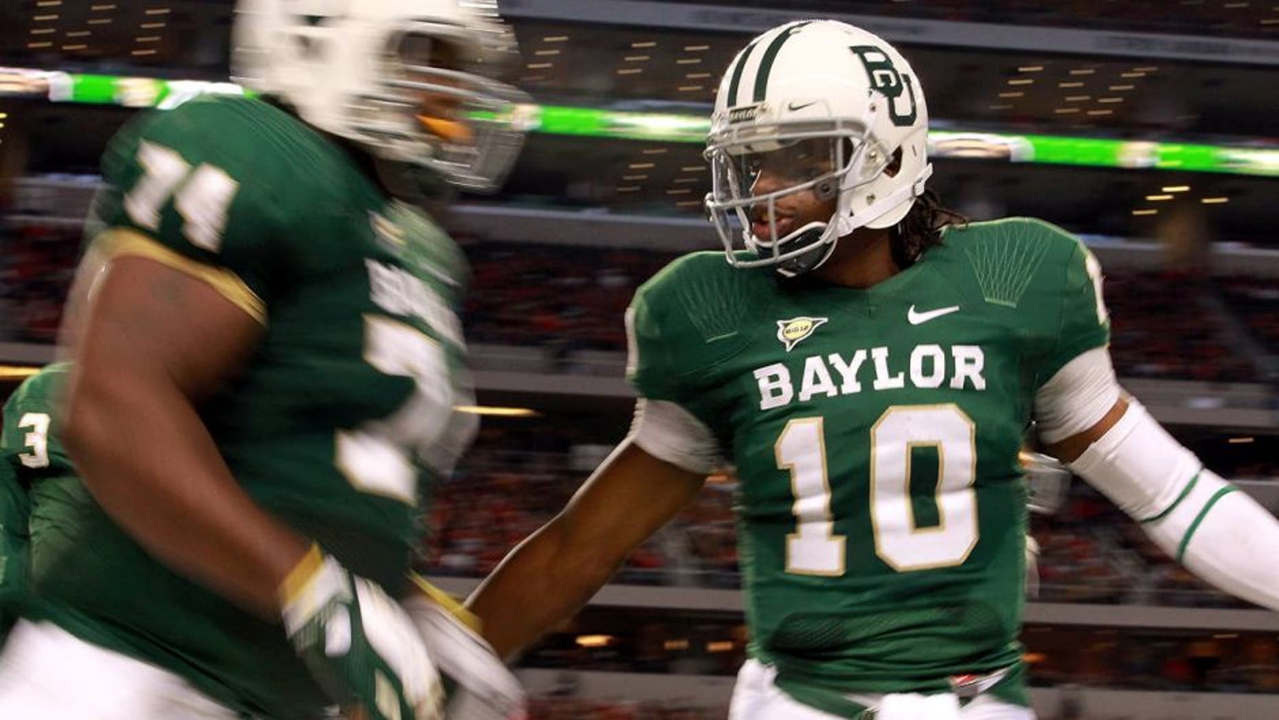 ARLINGTON, TX - NOVEMBER 26: Robert Griffin III #10 of the Baylor Bears celebrates a touchdown against the Texas Tech Red Raiders at Cowboys Stadium on November 26, 2011 in Arlington, Texas. (Photo by Ronald Martinez/Getty Images)