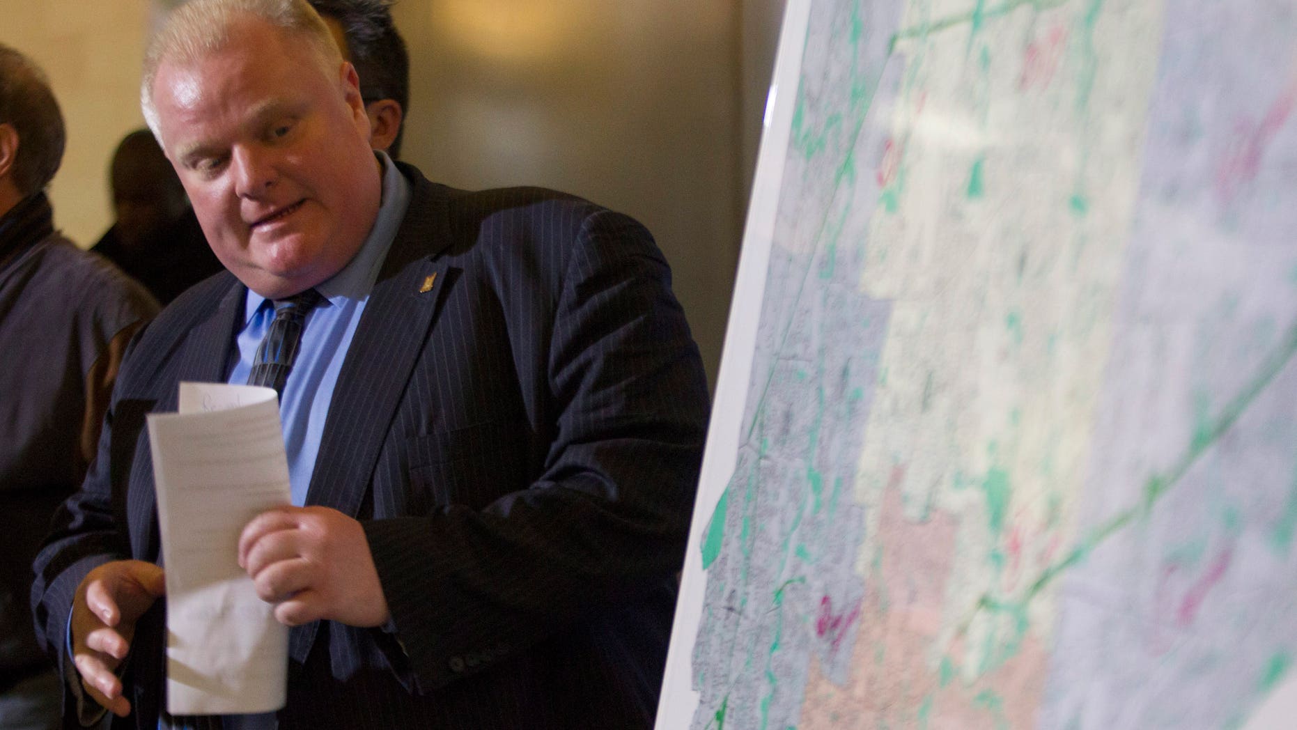 Toronto Mayor Rob Ford refers to a map of the city at a news conference to address an ice storm that left over 250,000 customers across the city without power on Sunday, Dec. 22, 2013. (AP Photo/The Canadian Press, Chris Young)