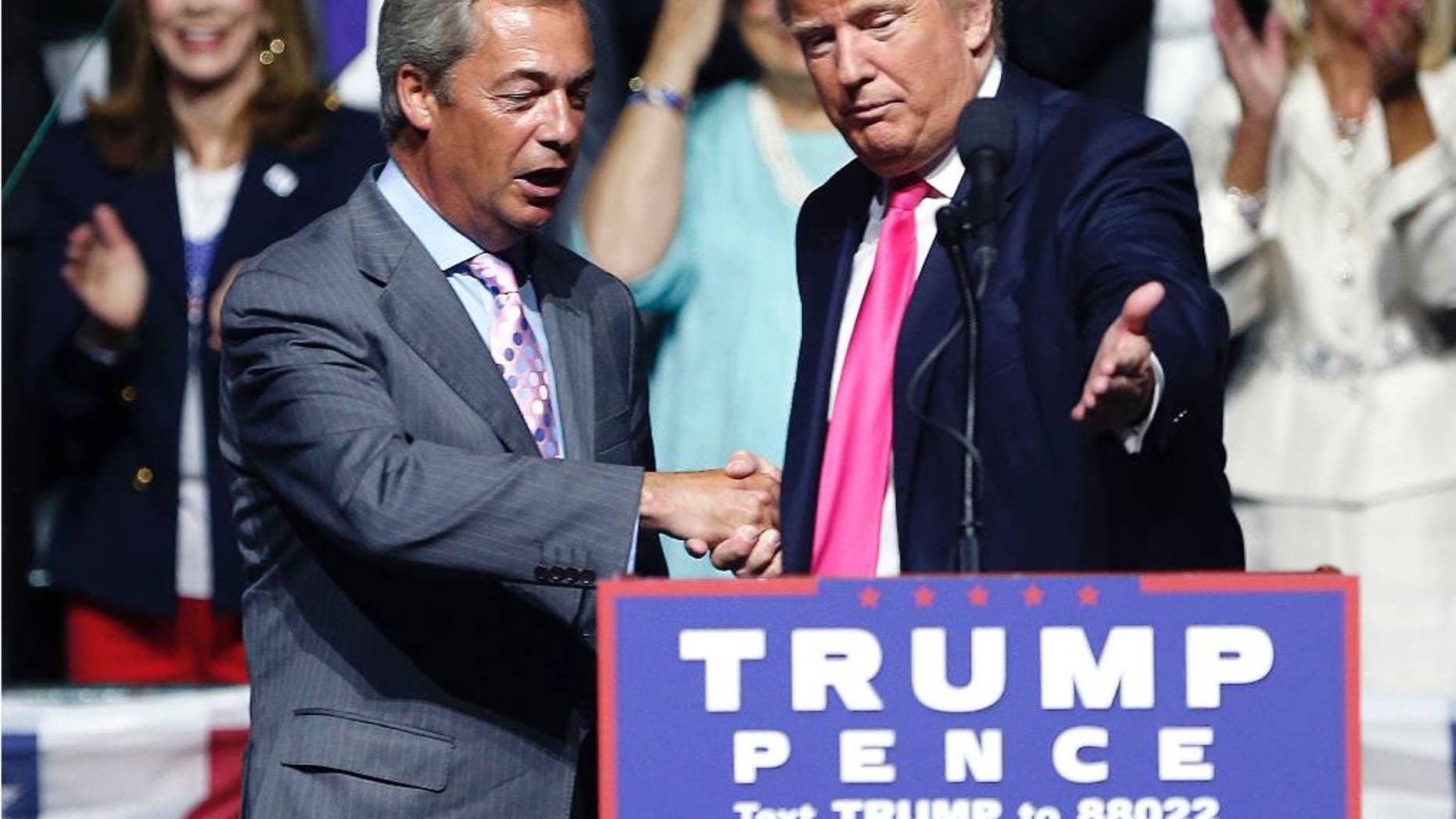 FILE - In this is a Wednesday, Aug. 24, 2016 file photo, Republican presidential candidate Donald Trump, right, welcomes pro-Brexit British politician Nigel Farage, to speak at a campaign rally in Jackson, Miss. Farage says he will attend Donald Trump's inauguration as U.S. president. Farage, one of Trump's strongest U.K. supporters, told Sky News that he had been invited by Mississippi Gov. Phil Bryant. He called the Jan. 20 ceremony in Washington, DC "a great, historic event" and Trump's election "a political revolution." (AP Photo/Gerald Herbert, File)