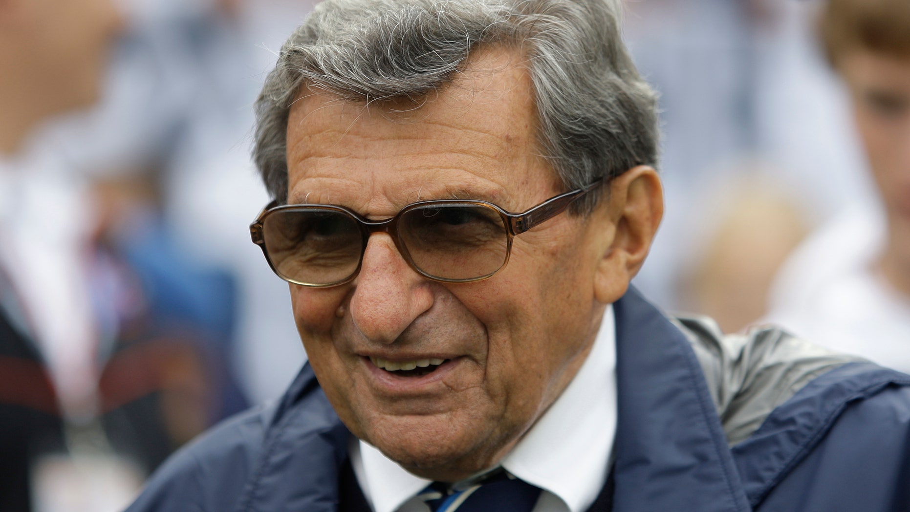 FILE - In this Sept. 12, 2009 file photo, Penn State coach Joe Paterno walks the field before their college football game against Syracuse in State College, Pa. The Hall of Fame coach died of lung cancer on Jan. 22, 2012, at age 85. On Tuesday, Jan. 22, 2013, exactly a year after his passing _ community residents have organized a vigil at a downtown mural that includes a depiction of Paterno. (AP Photo/Carolyn Kaster, File)