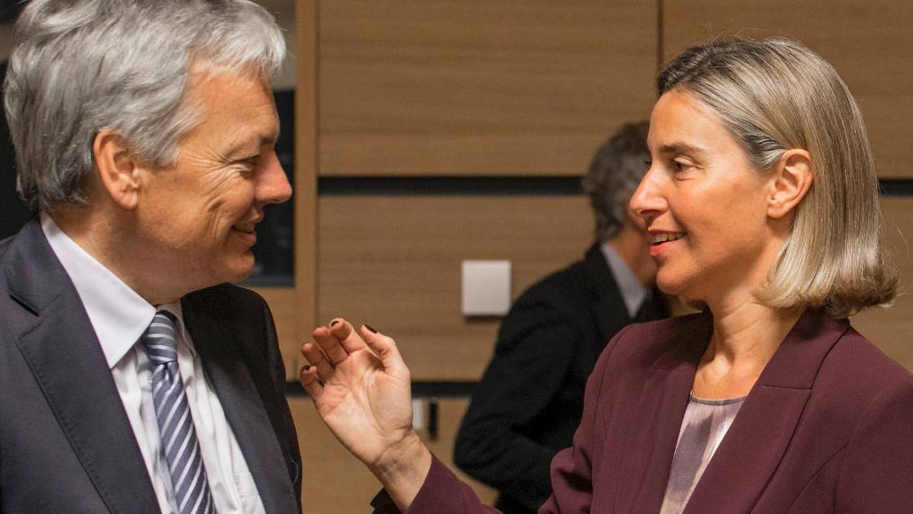 Belgium's foreign minister Didier Reynders, left, speaks with EU Council High representative Federica Mogherini during a meeting of EU foreign ministers at the EU Council building in Luxembourg, Monday, Oct. 17, 2016. European Union foreign ministers debated Monday whether to extend sanctions against the Syrian regime as political efforts to secure a cease-fire and access for humanitarian aid falter. (AP Photo/Olivier Matthys)