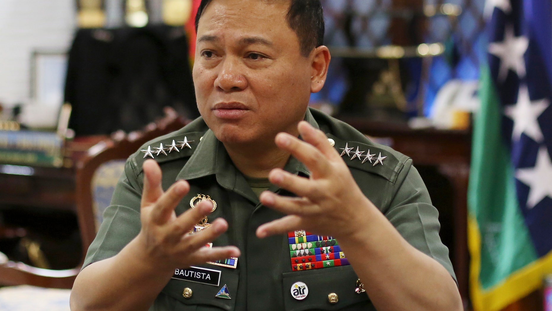 Philippine Military Chief Emmanuel Bautista gestures during an interview at Camp Aquinaldo military headquarters in suburban Quezon city, north of Manila, Philippines on Thursday, Feb. 20, 2014. Bautista says Beijing’s territorial claims in the South China Sea are “nonsense” and vowed to defend fishermen if they face intimidation by Chinese naval forces in the waters. (AP Photo/Aaron Favila)