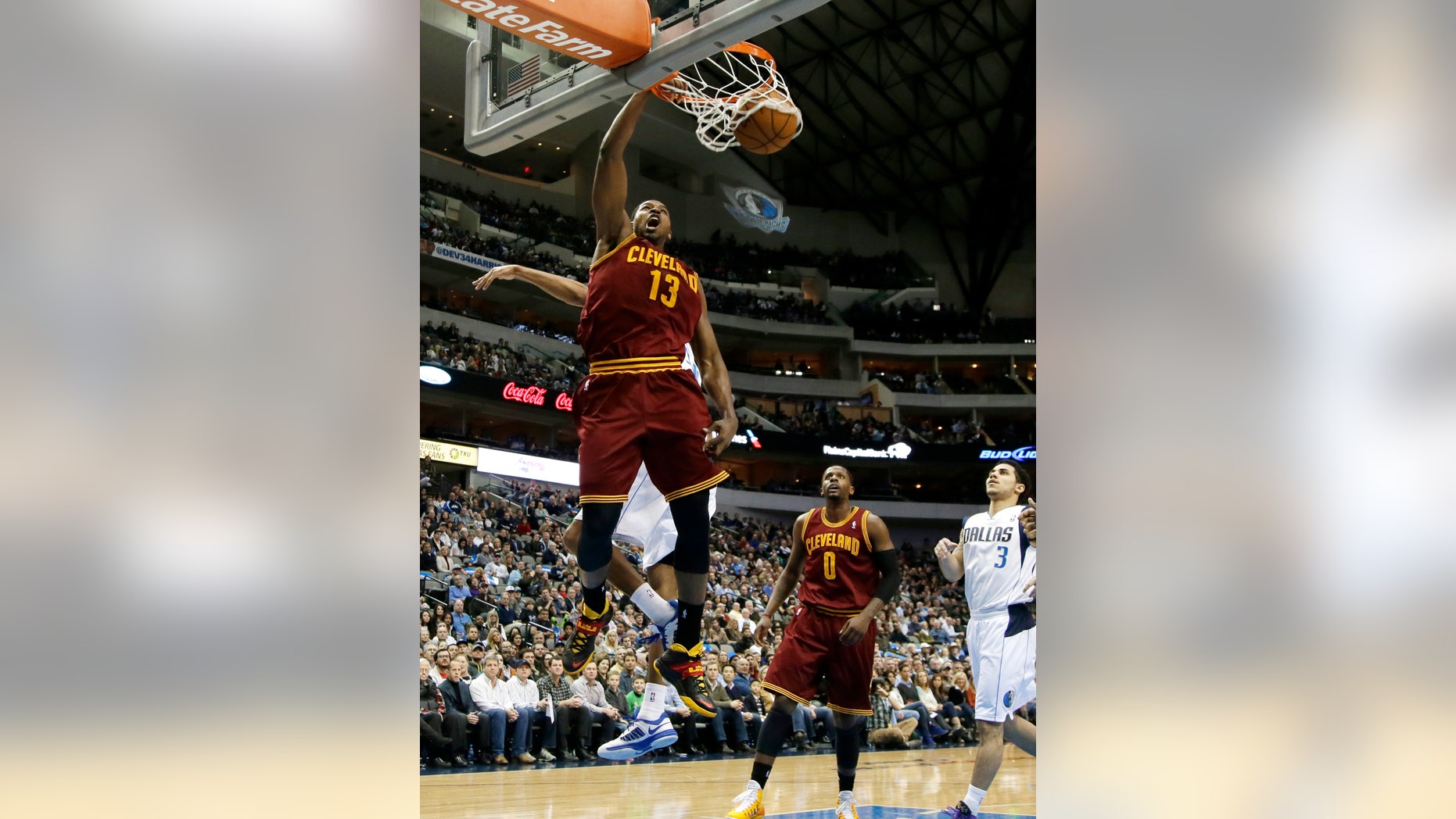 Cleveland Cavaliers' Tristan Thompson (13) dunks after getting past Dallas Mavericks' Brandan Wright, rear, as C.J. Miles (0) and Shane Larkin (3) watch in the first half of an NBA basketball game, Monday, Feb. 3, 2014, in Dallas. (AP Photo/Tony Gutierrez)