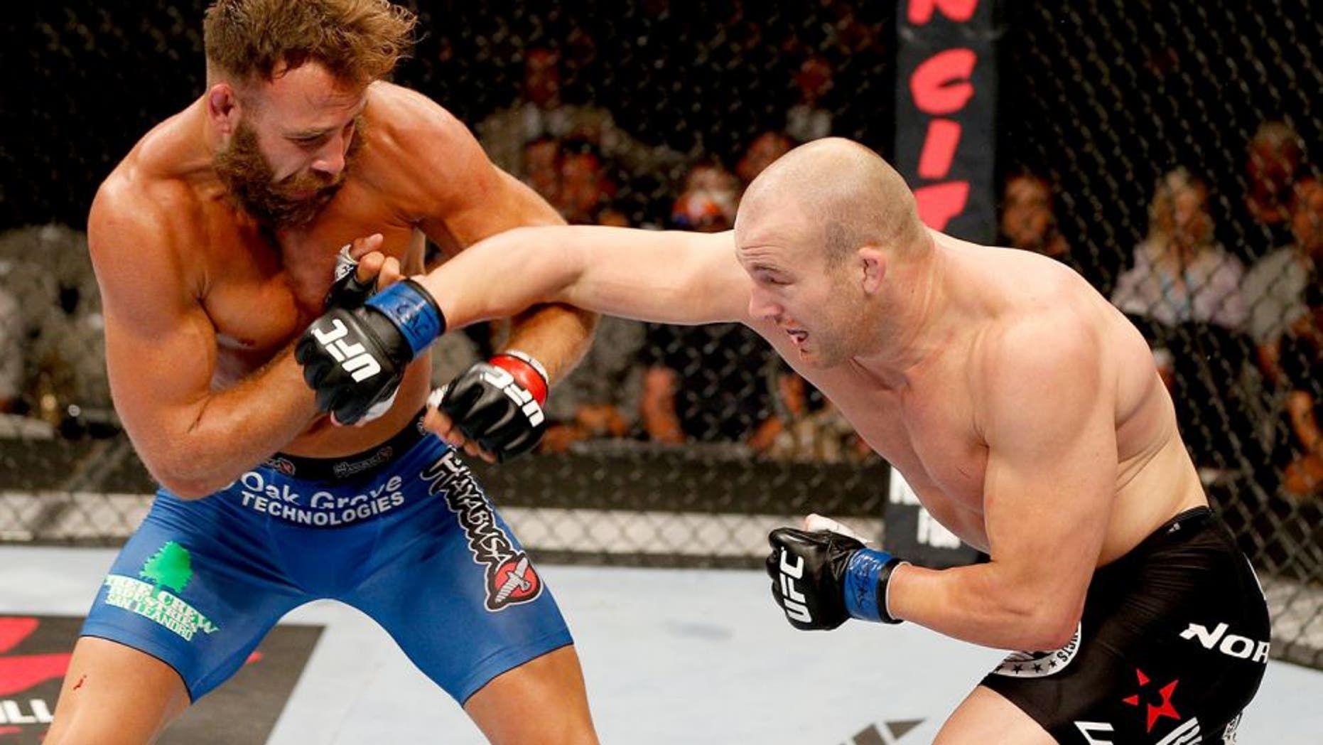 SAN JOSE, CA - JULY 26: (R-L) Patrick Cummins punches Kyle Kingsbury in their light heavyweight bout during the UFC Fight Night event at SAP Center on July 26, 2014 in San Jose, California. (Photo by Josh Hedges/Zuffa LLC/Zuffa LLC via Getty Images)