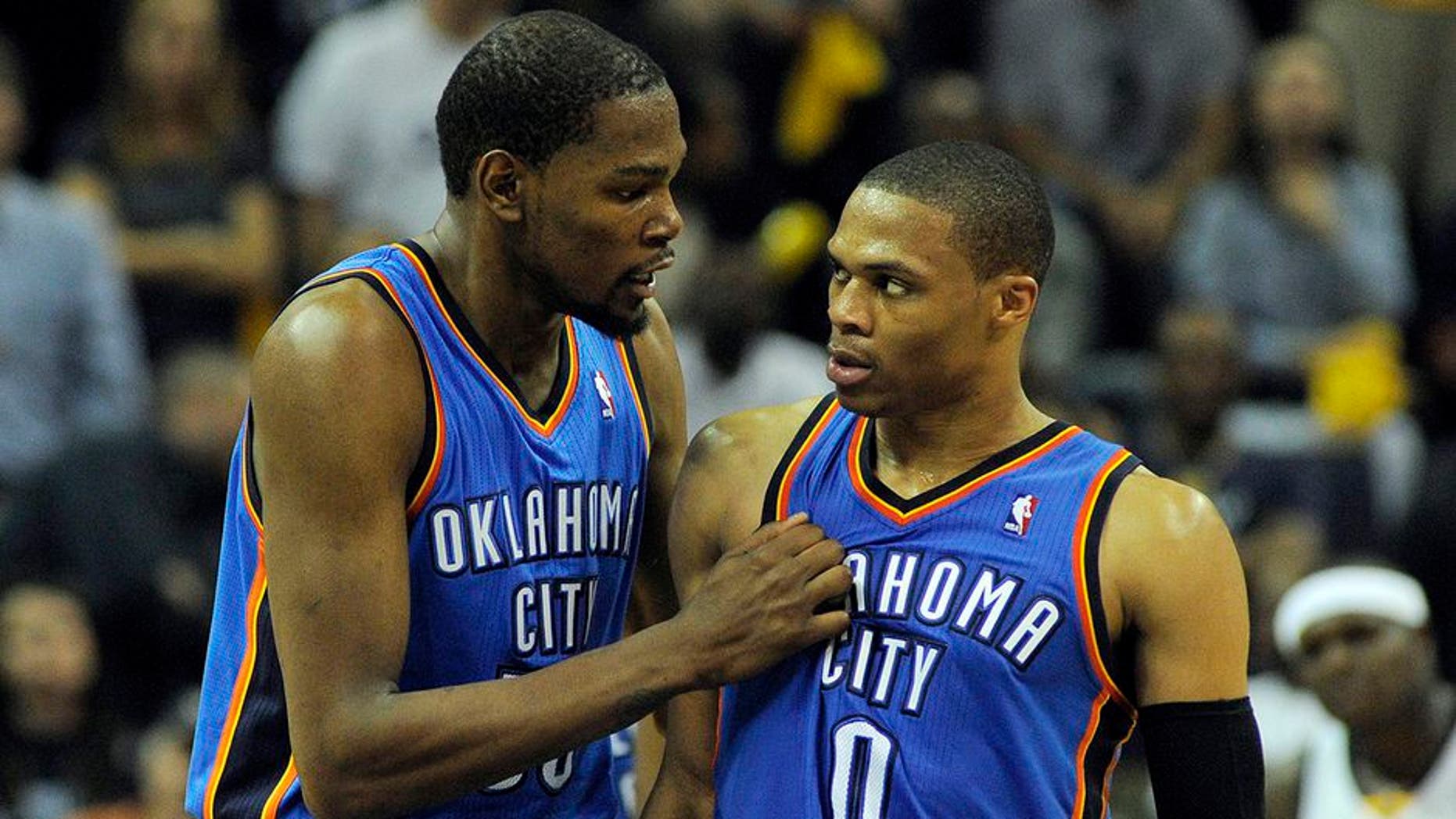 Apr 24, 2014; Memphis, TN, USA; Oklahoma City Thunder forward Kevin Durant (35) and guard Russell Westbrook (0) talk during the game against the Memphis Grizzlies in game three of the first round of the 2014 NBA Playoffs at FedExForum. Memphis Grizzlies beat Oklahoma City Thunder in overtime 98 - 95. Mandatory Credit: Justin Ford-USA TODAY Sports
