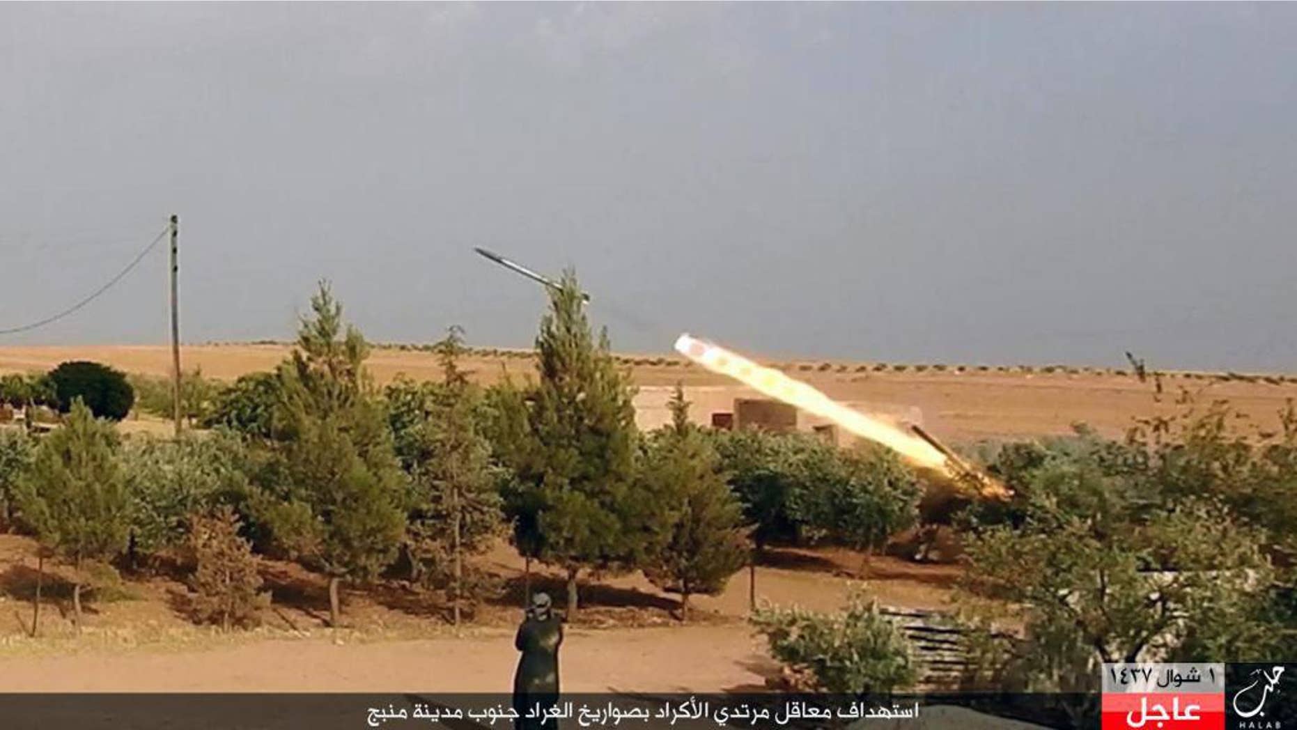 Kurdish-led forces in Manbij targeted by an ISIS missile, in a July image.
