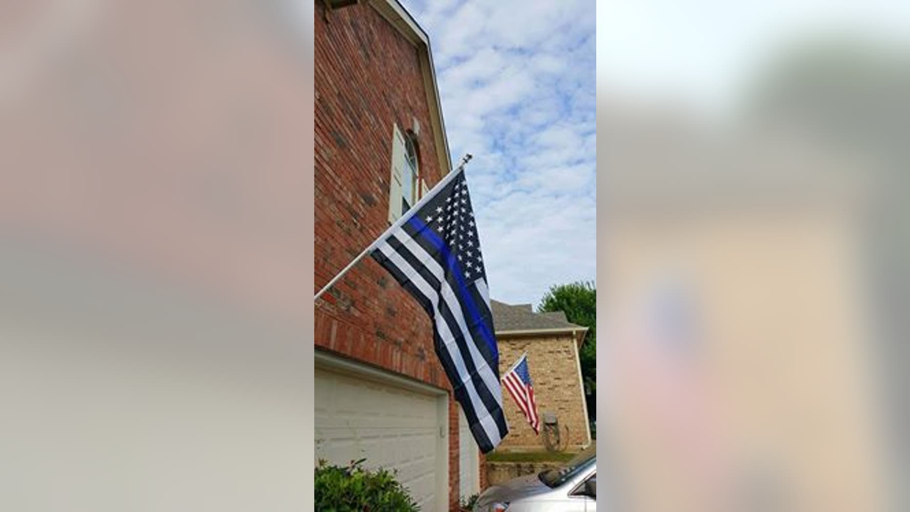 The black and white version of the U.S. flag adorned with a blue stripe.