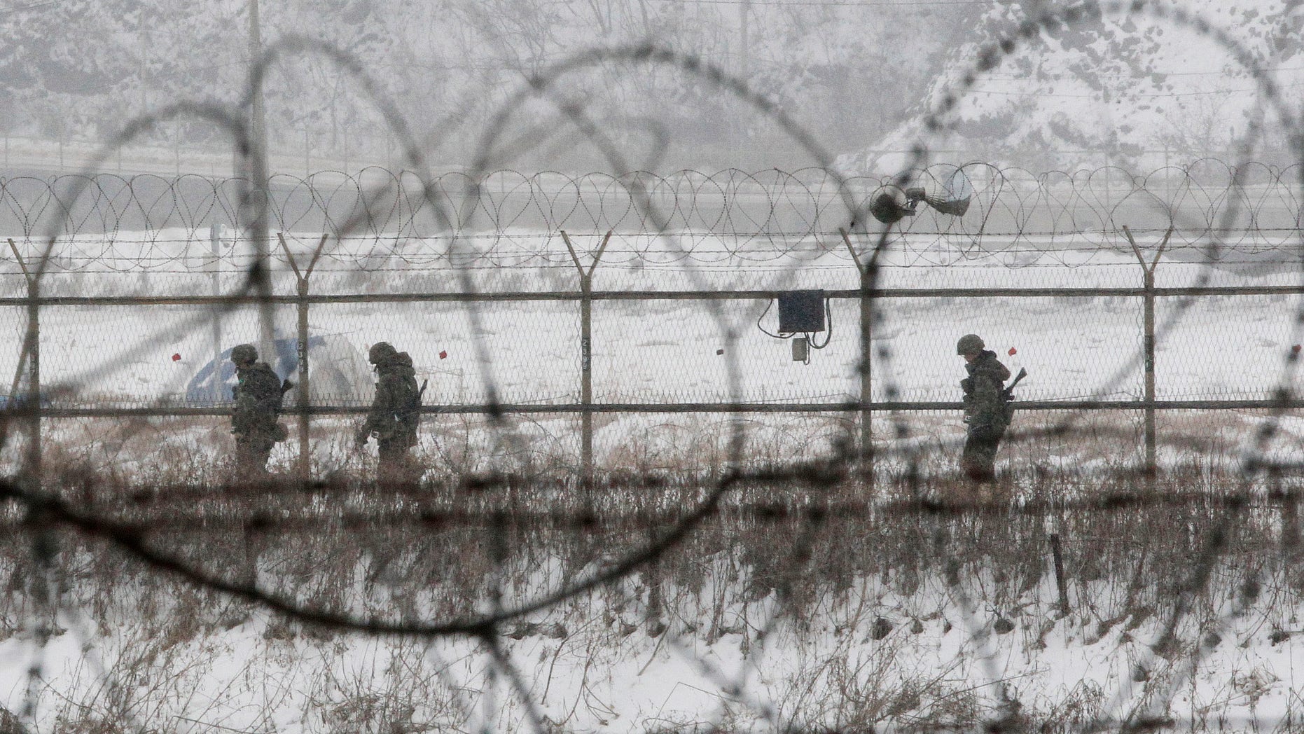 Feb. 12, 2013: South Korean army soldiers patrol along barbed-wire fences at the Imjingak Pavilion, near the demilitarized zone of Panmunjom, in Paju, South Korea.