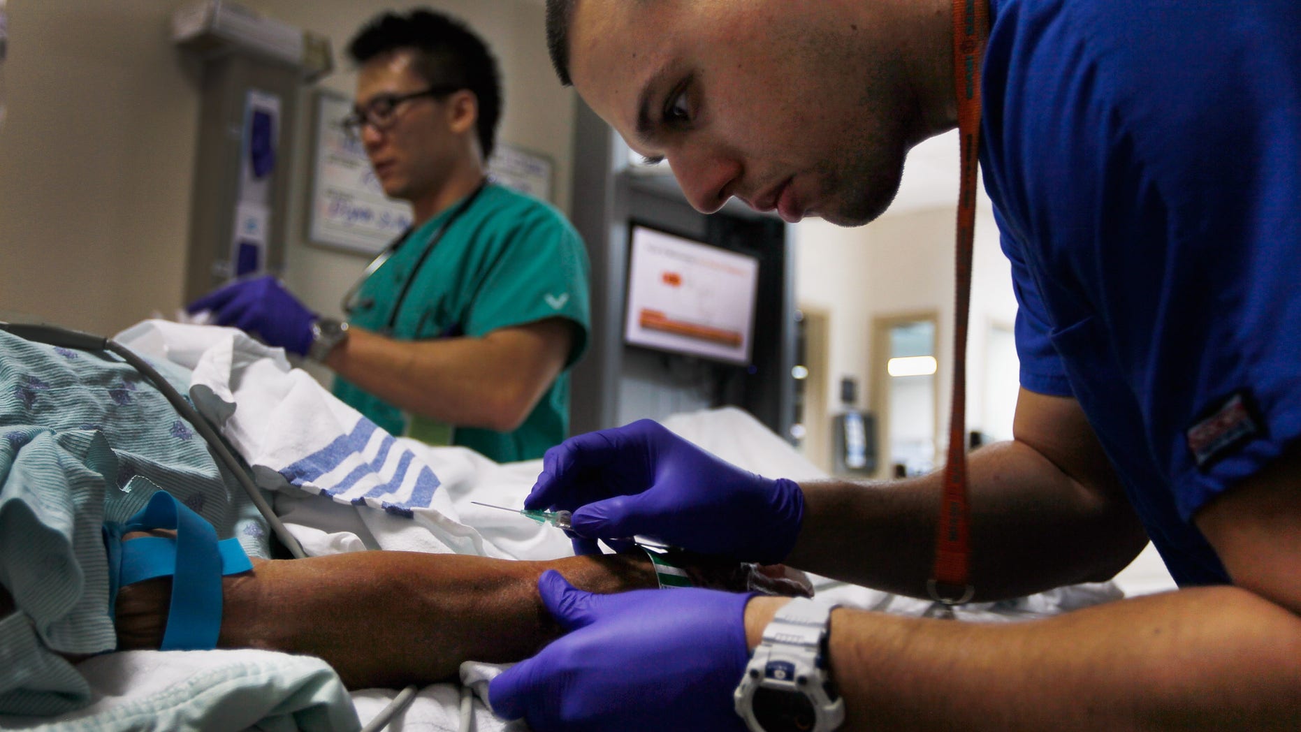 MIAMI, FL - APRIL 30: Paramedic Christopher Gutierrez prepares to draw blood from a patient at the University of Miami Hospital's Emergency Department on April 30, 2012 in Miami, Florida. As people wait to hear from the United States Supreme Court on its decision of the constitutionality of the Affordable Care Act, some experts say that if the act is overturned, a decision expected later this year, people that now have insurance will no longer be eligible and will be kicked back into a system where the emergency department is their first visit when sick. (Photo by Joe Raedle/Getty Images)