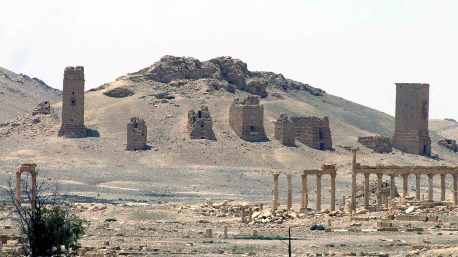 FILE - This file photo released on Sunday, May 17, 2015, by the Syrian official news agency SANA, shows the general view of the ancient Roman city of Palmyra, northeast of Damascus, Syria. A Syrian official said Wednesday, June 24, 2015 that the Islamic State group has destroyed two mausoleums in the historic central town of Palmyra. (SANA via AP, File)