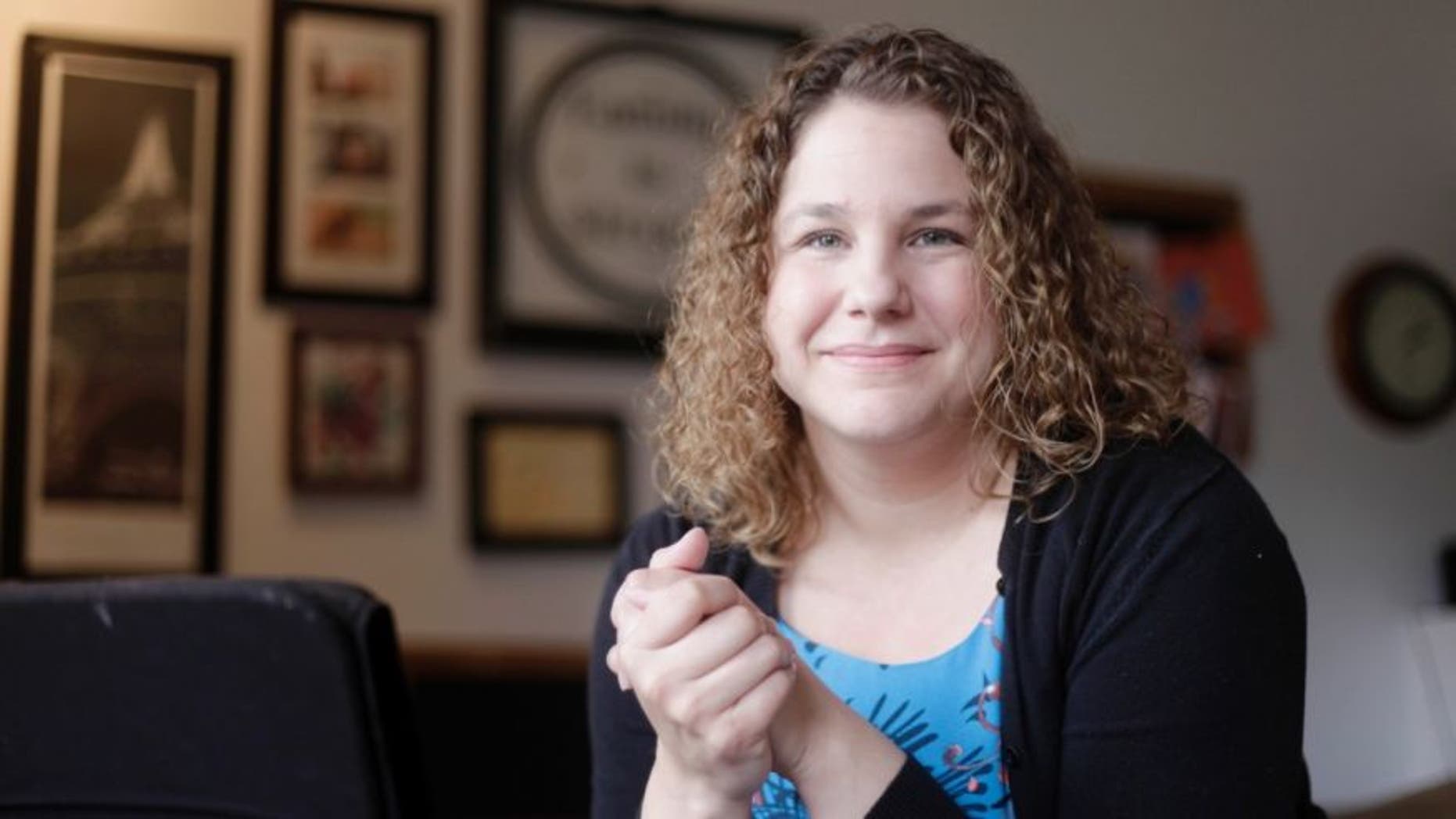 In this Friday, Nov. 20, 2015, photo, Andrea Quenette, an assistant professor of communication studies at the University of Kansas, poses for a photo at her home in Lawrence, Kan
