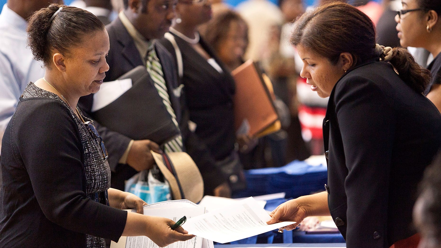 NEW YORK, NY - JUNE 07: A woman speaks to a potential employer at a New York state jobs fair in the Harlem Armory on June 7, 2012 in New York City. The job fair was put together by the New York State Department of Labor and New York State assemblyman Keith Wright. The U.S. Department of Labor has coined the month of June as "Jobs Fair Month." (Photo by Andrew Burton/Getty Images)