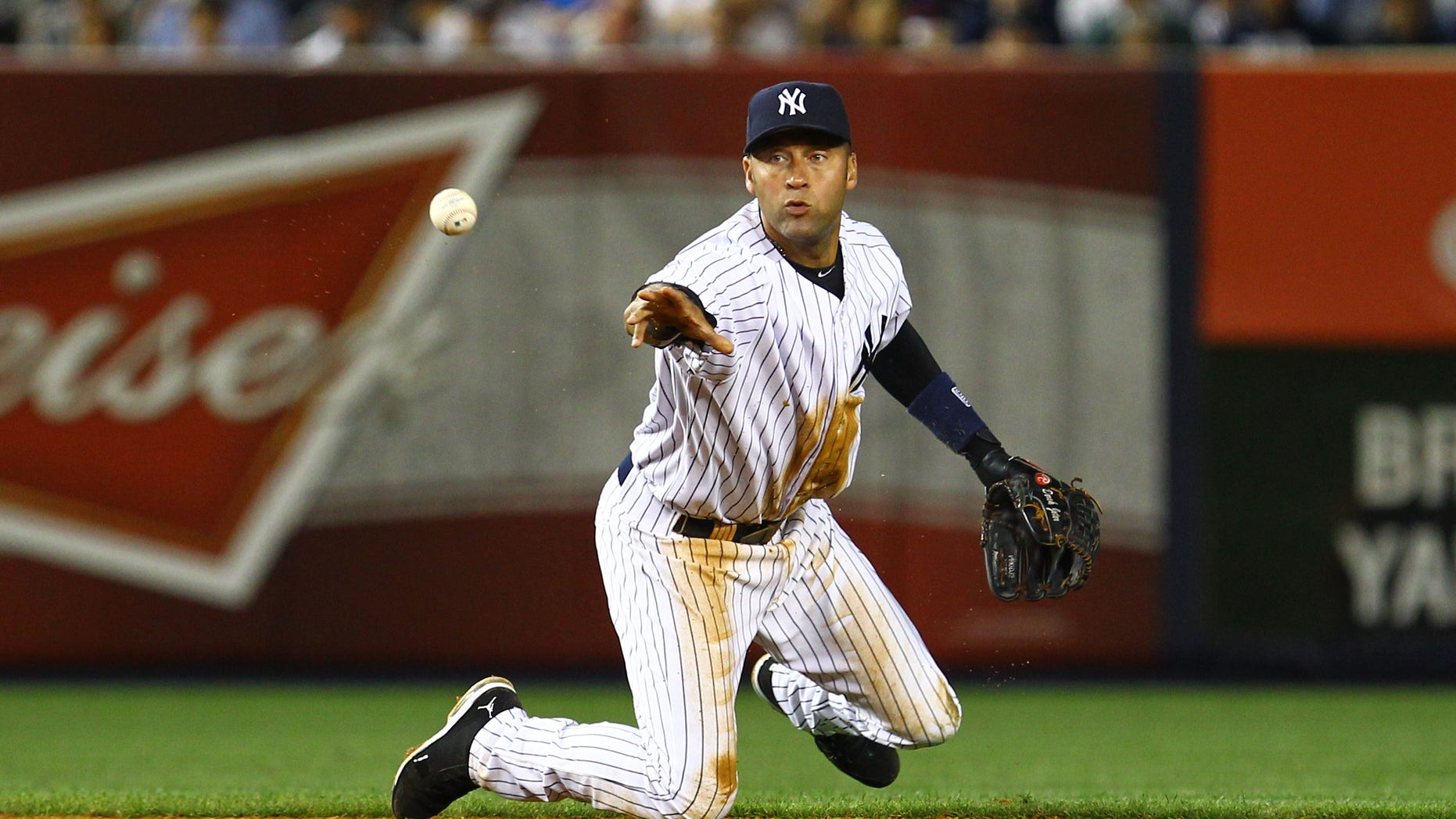 June 18, 2012: Derek Jeter of the New York Yankees flips the ball to second base to end the seventh inning from a ball hit by Michael Bourn of the Atlanta Braves during their game at Yankee Stadium in New York City. (Al Bello/Getty Images)
