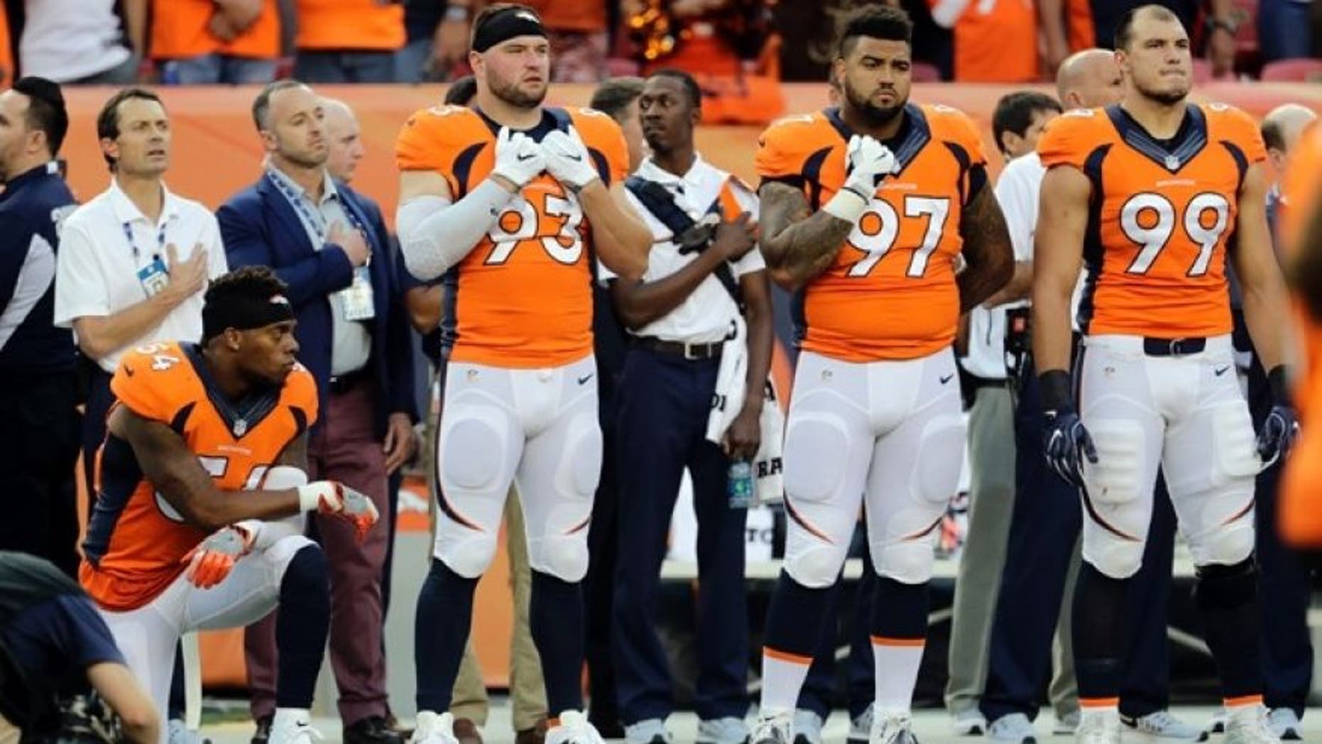 Denver Broncos inside linebacker Brandon Marshall (54) kneels during the National Anthem prior to an NFL football game against the Carolina Panthers, Thursday, Sept. 8, 2016, in Denver.