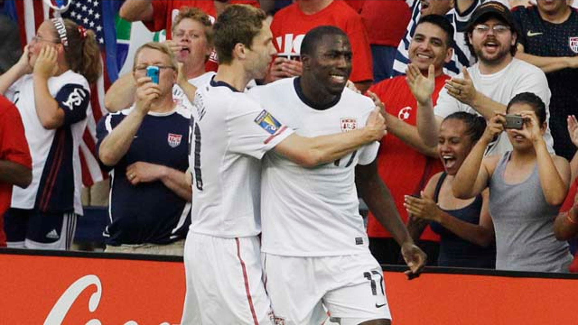 USA attacker Jozy Atidore (17) is congratulated by teammate Clarence Goodson (21) following his goal against Guadeloupe during the first half of a Gold Cup soccer match in Kansas City, Kan., Tuesday, June 14, 2011. (AP Photo/Orlin Wagner)