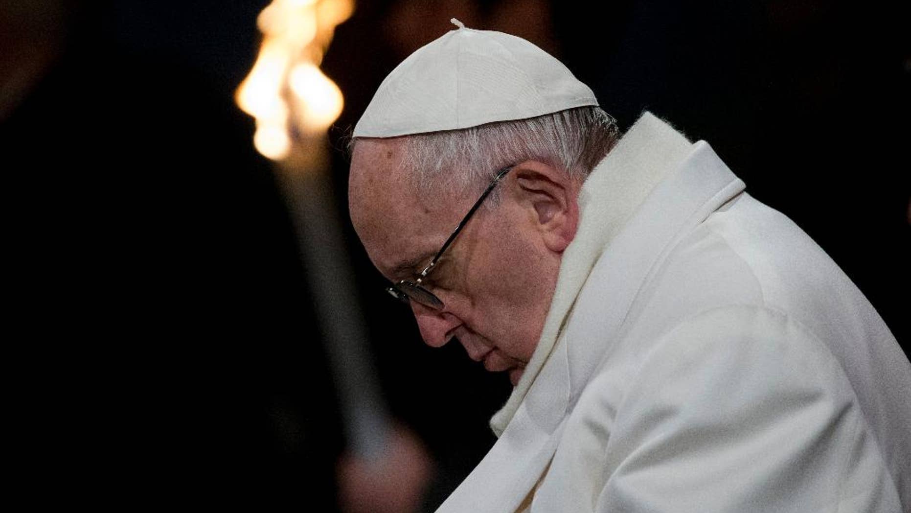 Pope Francis leads the Via Crucis (Way of the Cross) torchlight procession celebrated in front of the Colosseum on Good Friday in Rome, Friday, March 25, 2016.