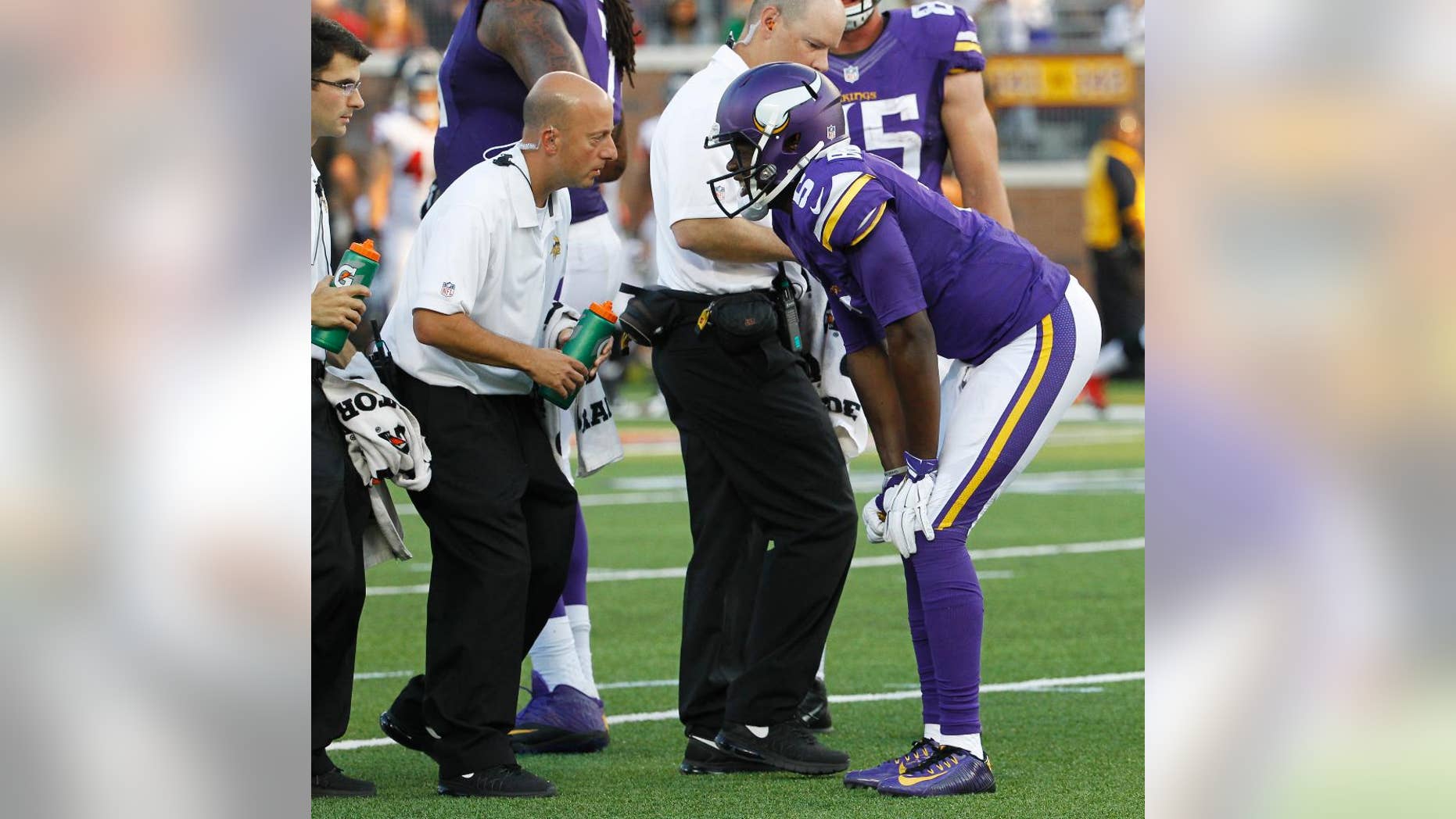 FILE - In this Sunday, Sept. 28, 2014, file photo, Minnesota Vikings quarterback Teddy Bridgewater talks to a trainer after getting injured in the second half of an NFL football game against the Atlanta Falcons in Minneapolis. Bridgewater's first start for the Vikings couldn't have been better, except of course for the sprained left ankle in the fourth quarter that forced him out of the 41-28 victory over Atlanta.(AP Photo/Ann Heisenfelt, File)