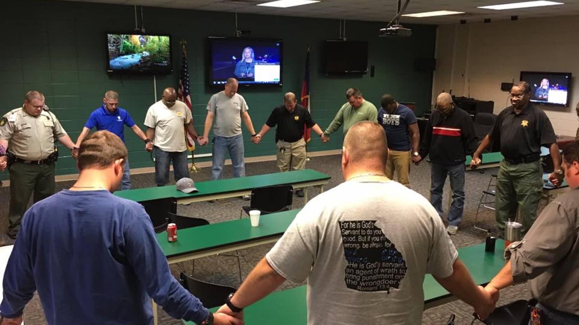 Deputies praying after the shooting.