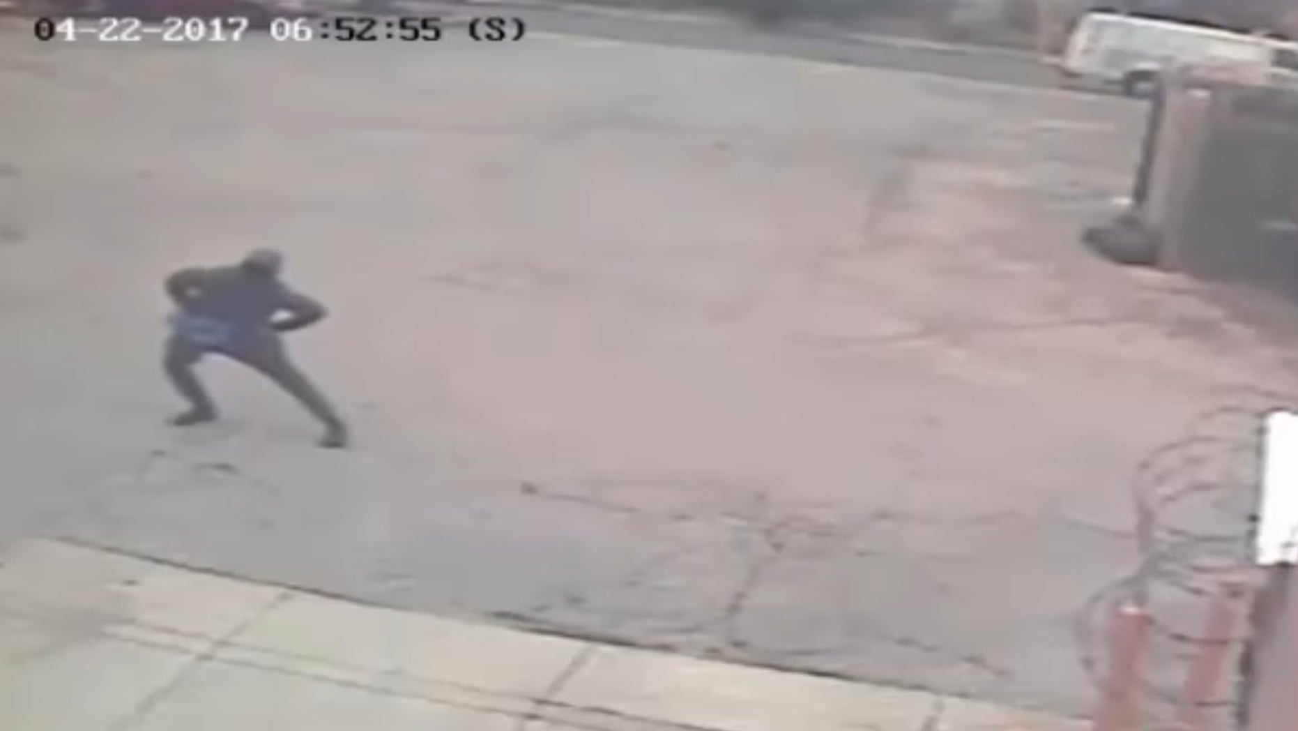 The suspect stretching before robbing a Dunkin' Donuts.
