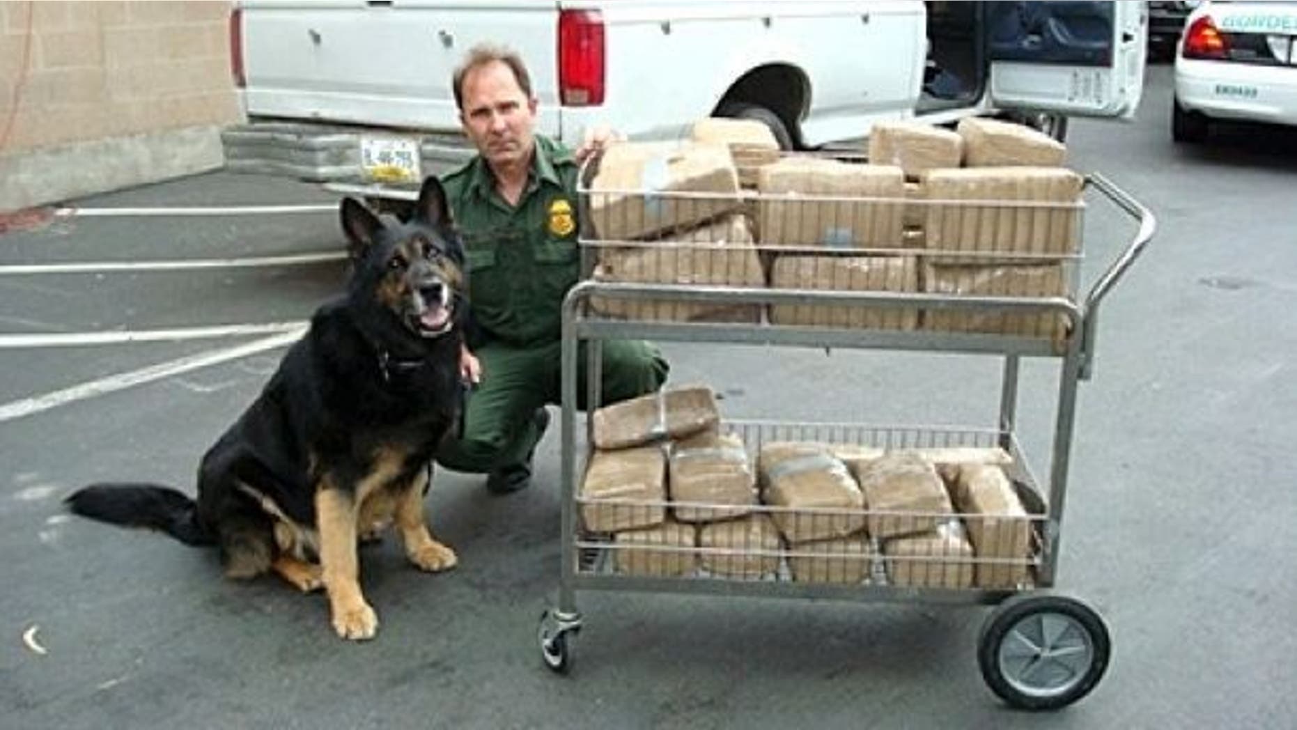 Supervisory Border Patrol Agent Peter Dame with K-9 Don.