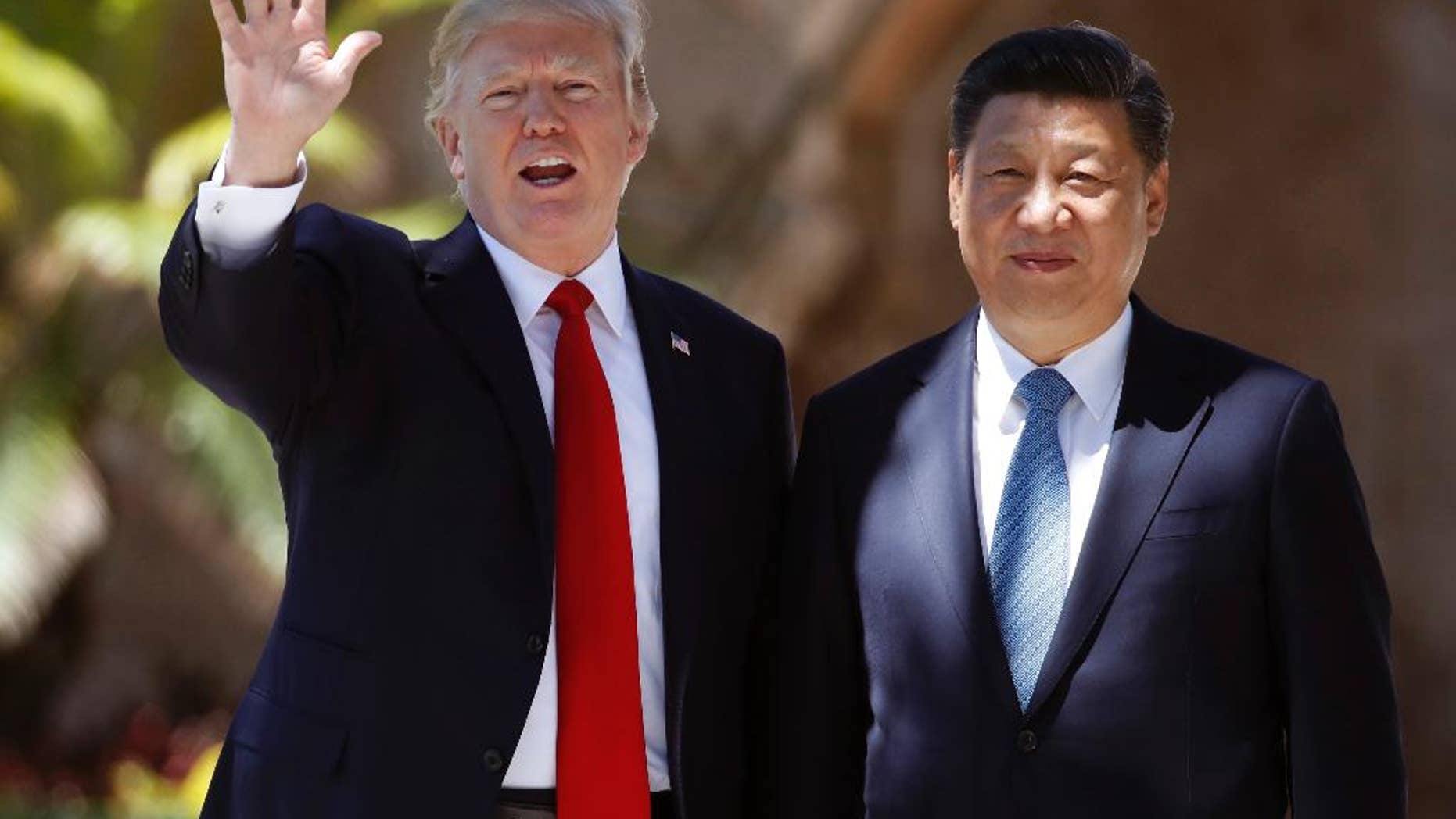 FILE - In this Friday, April 7, 2017, file photo, U.S. President Donald Trump, left, and Chinese President Xi Jinping pause for photographs at Mar-a-Lago in Palm Beach, Fla. North Korea often marks significant dates by displaying military capability, and South Korean officials say there's a chance the country will conduct its sixth nuclear test or its maiden test launch of an ICBM around the founding anniversary of its military on Tuesday, April 25. Trump spoke by phone with both the Japanese and Chinese leaders Monday, April 24. China's official broadcaster CCTV quoted Xi telling Trump that China strongly opposed North Korea's nuclear weapons program and hoped "all parties will exercise restraint and avoid aggravating the situation." (AP Photo/Alex Brandon, File)