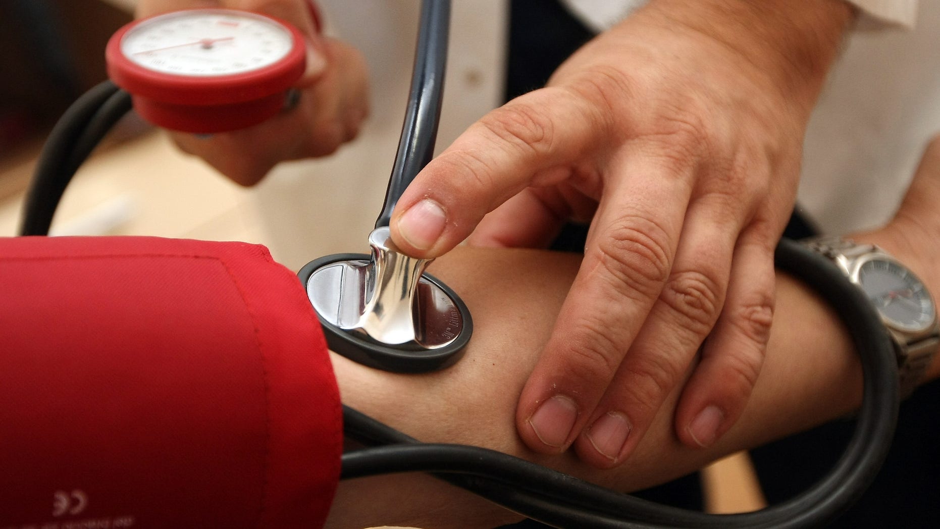 BERLIN, GERMANY - SEPTEMBER 05: A doctor checks a patient's blood pressure on September 5, 2012 in Berlin, Germany. Doctors in the country are demanding higher payments from health insurance companies (Krankenkassen). Over 20 doctors' associations are expected to hold a vote this week over possible strikes and temporary closings of their practices if assurances that a requested additional annual increase of 3.5 billion euros (4,390,475,550 USD) in payments are not provided. The Kassenaerztlichen Bundesvereinigung (KBV), the National Association of Statutory Health Insurance Physicians, unexpectedly broke off talks with the health insurance companies on Monday. (Photo by Adam Berry/Getty Images)