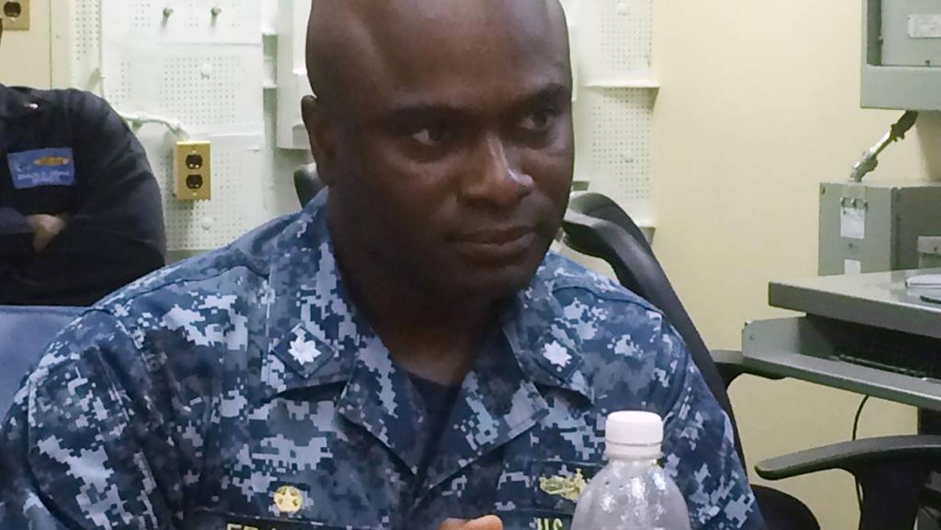 Cmdr. Robert Francis Jr., skipper of the USS Lassen, speaks to a reporter Thursday, Nov. 5, 2015, aboard the USS Theodore Roosevelt in the South China Sea. A week earlier, the USS Lassen challenged China's claim to a 12-mile territorial limit around Subi Reef in the Spratly Islands about 150 miles to 200 miles from where the Theodore Roosevelt was sailing Thursday. (AP Photo/Bob Burns)