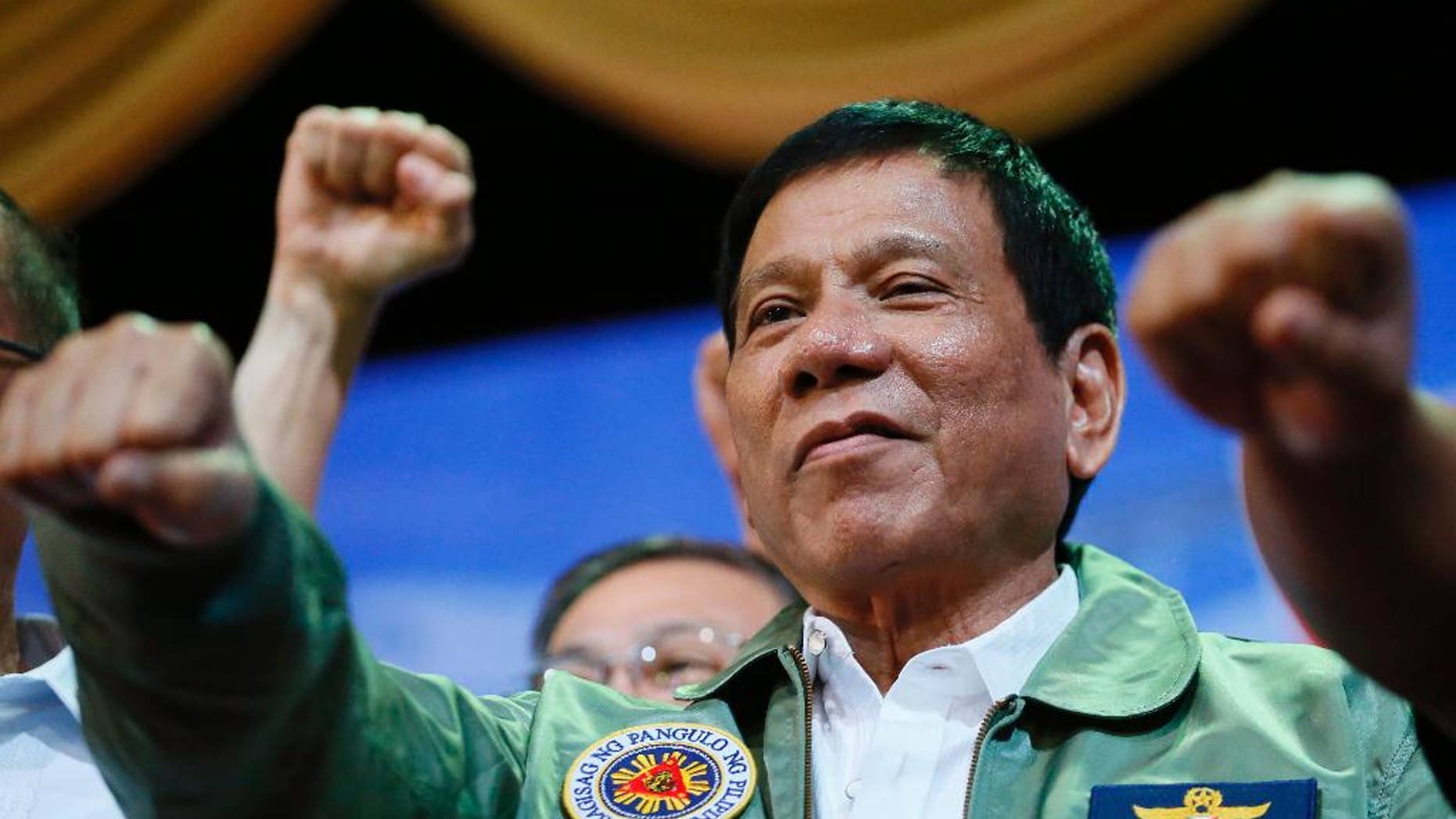 FILE - In this Tuesday, Sept. 13, 2016, file photo, Philippine President Rodrigo Duterte poses with a fist bump during the anniversary of the 250th Presidential Airlift Wing at the Philippine Air Force headquarters in Pasay city, southeast of Manila, Philippines. Impassioned speeches by Duterte about the United States, the European Union and the United Nations have repeatedly led his government to issue clarifications, though he has been on the job less than three months. (AP Photo/Bullit Marquez, File)